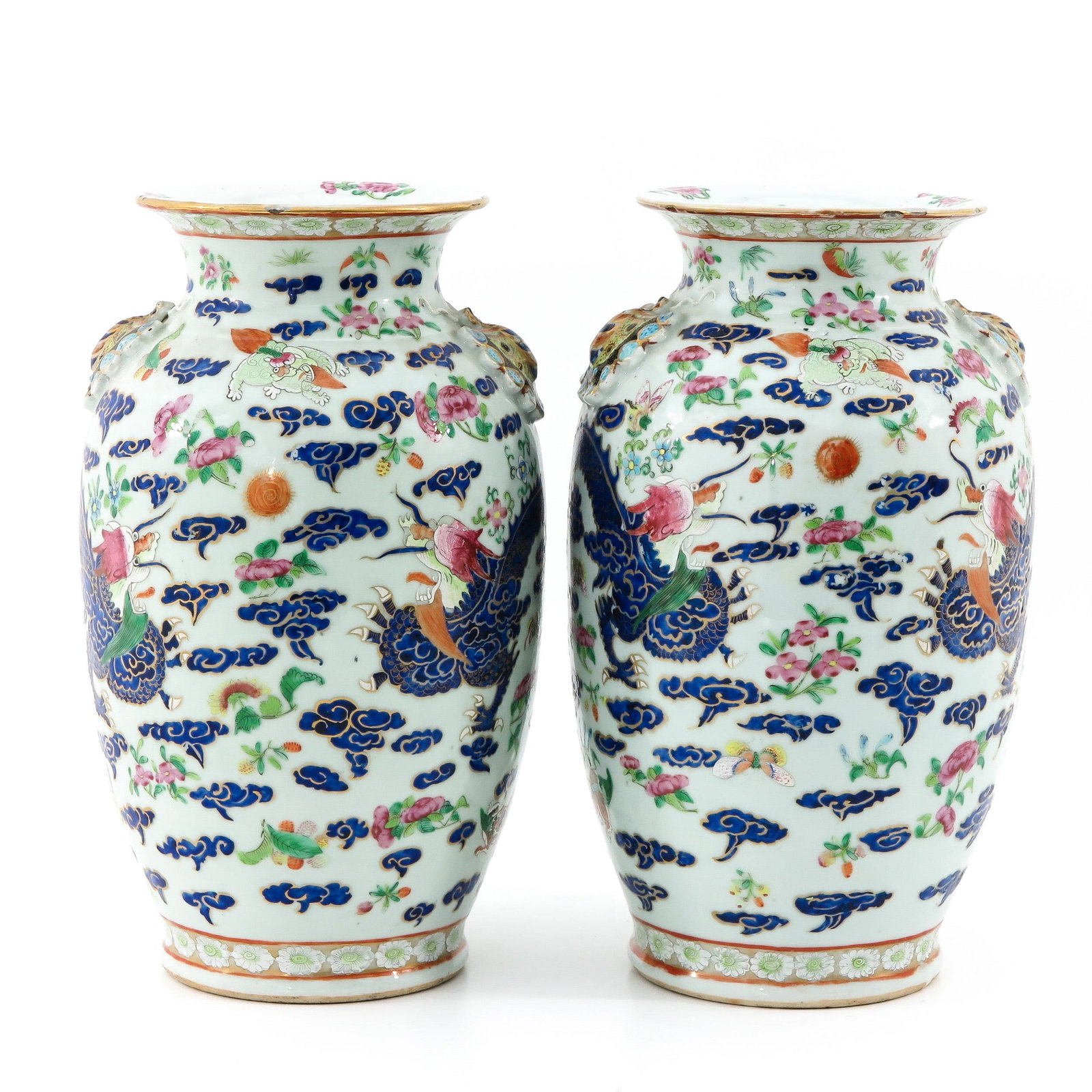 A Pair of Famille Rose Vases: Decorated with temple lions, dragons and butterflies, figural butterfly handles, 19th Century, 39 cm. tall. chip on rim.