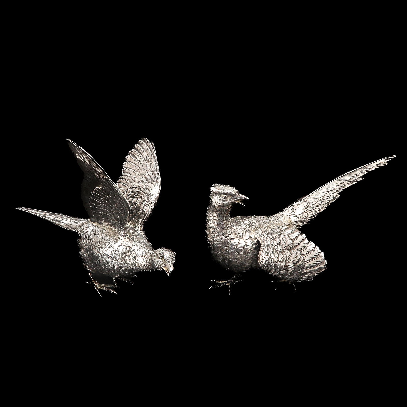 A Pair of Silver Bird Table Sculptures: 24 cm. long.