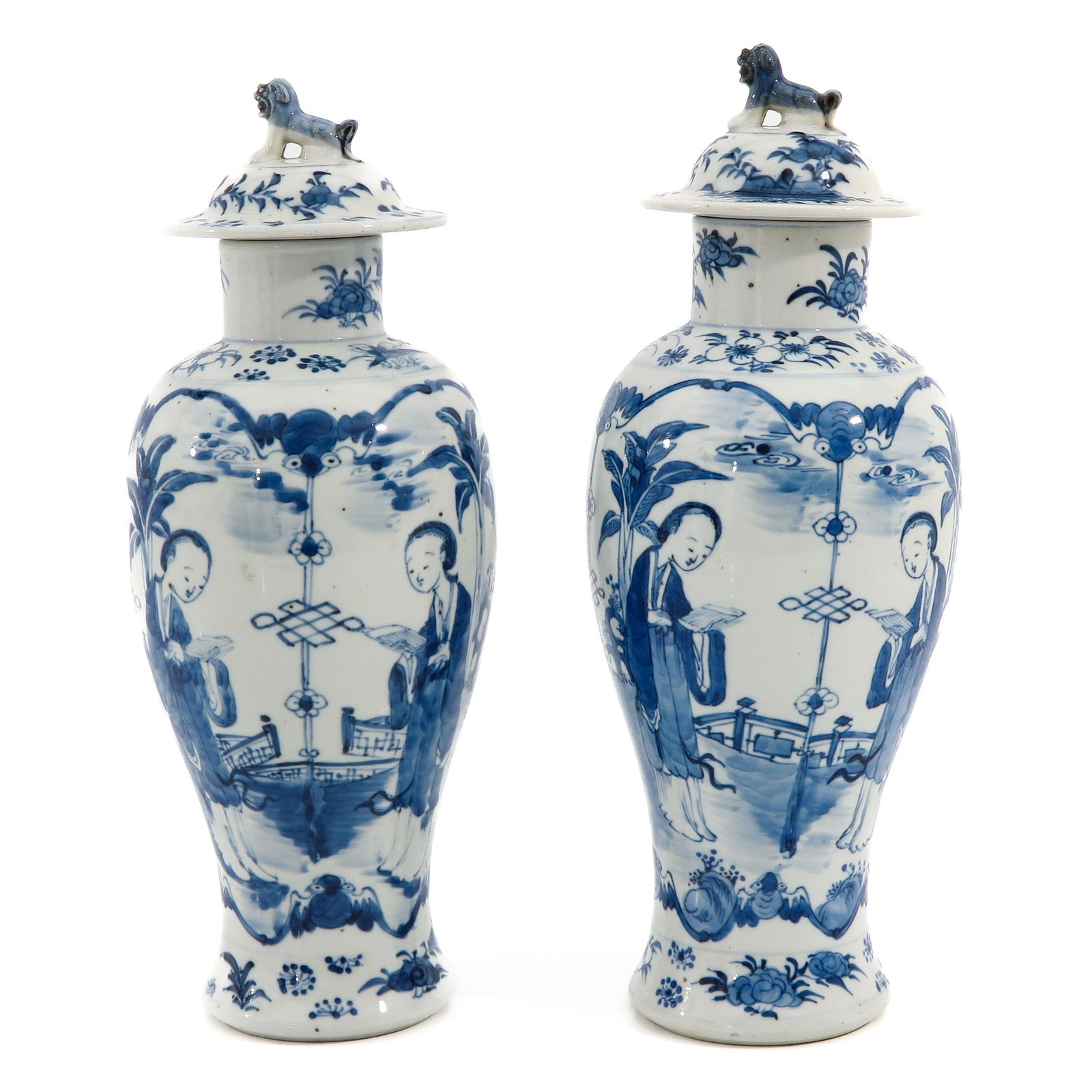 A Pair of Blue and White Garniture Vases: Depicting Chinese ladies in garden, 37 cm. tall.