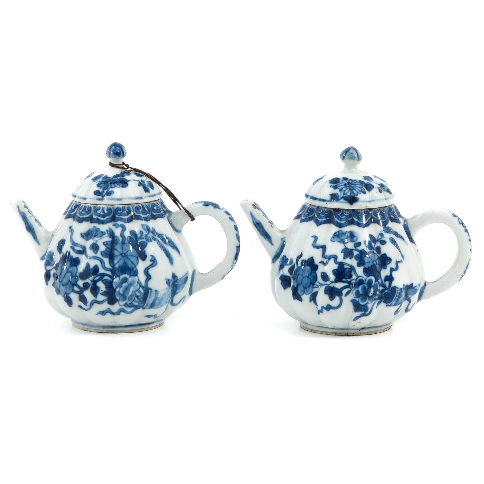 A Pair of Blue and White Teapots: Floral decor, 18th Century, 11 cm. tall, chip and hairline.