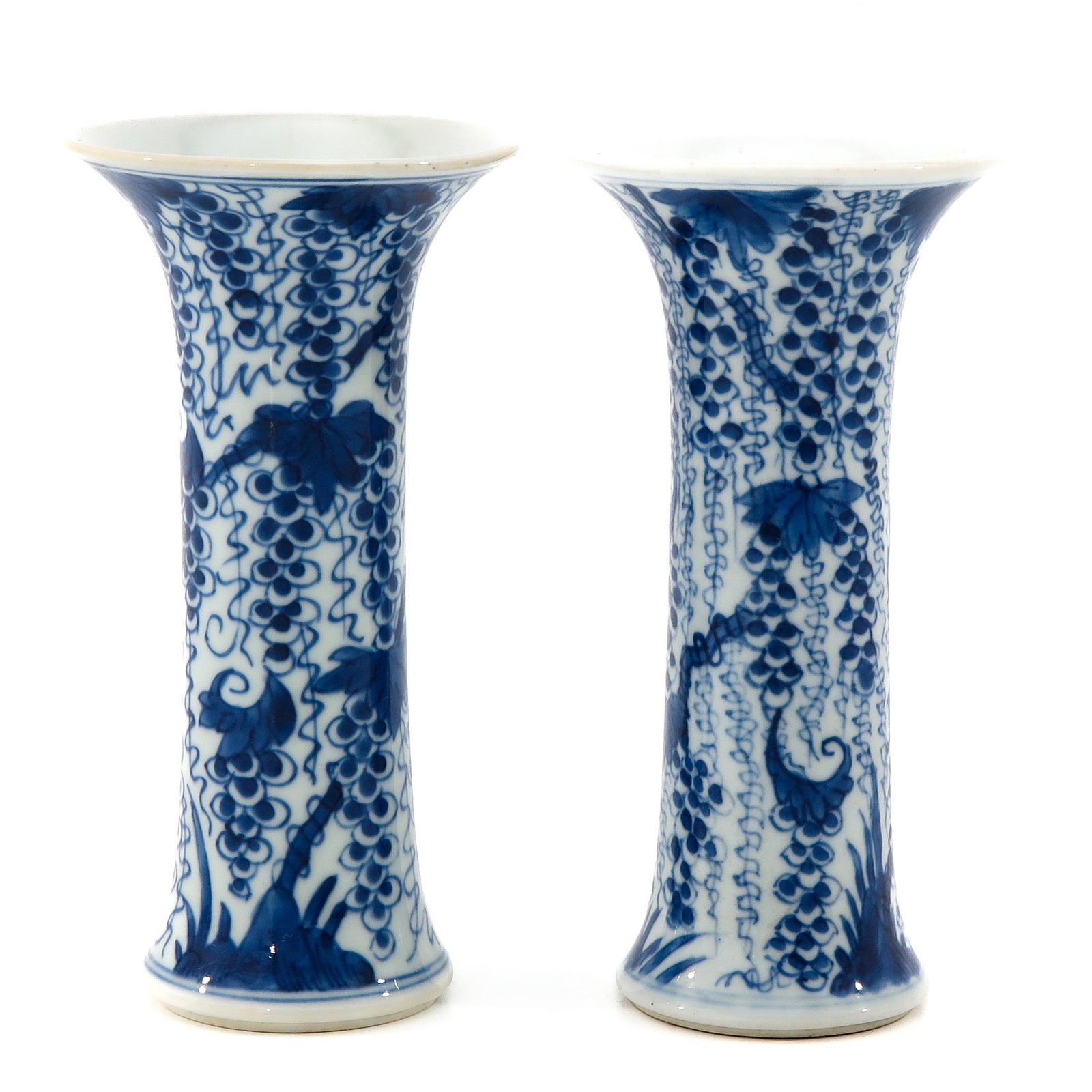 A Pair of Blue and White Vases: Depicting grape vines, 19 cm. tall.