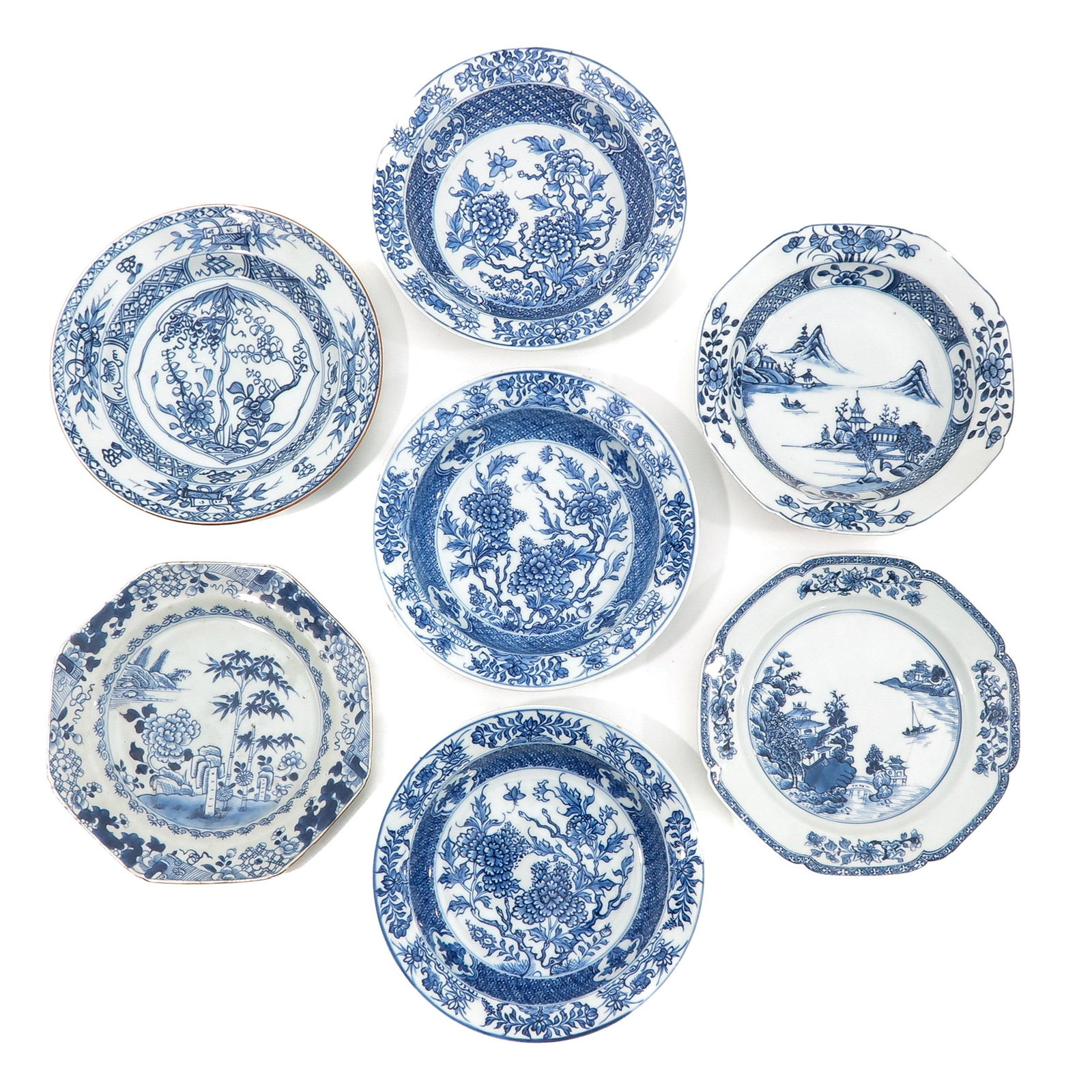 A Collection of Blue and White Plates: In a variety of decors, some 18th Century, 23 cm. in diameter, in diverse conditions.