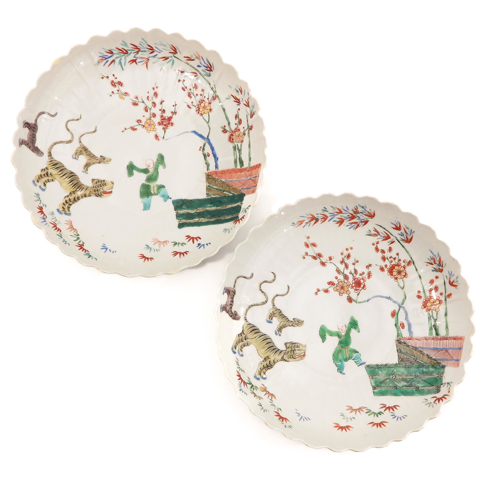 A Pair of Famille Verte Plates: Depicting Chinese boy with tigers 25 cm. in diameter, restored.