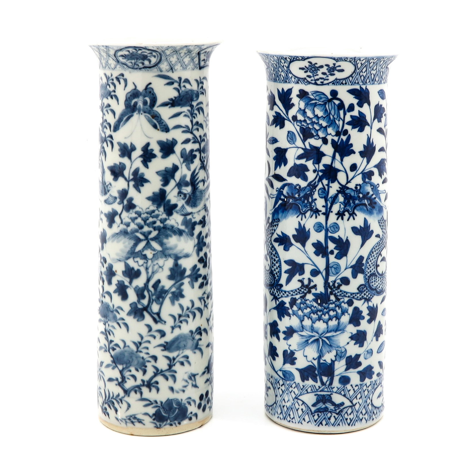A Pair of Blue and White Vases: Decorated with flowers and birds, Kangxi mark, 30 cm. tall, chip.