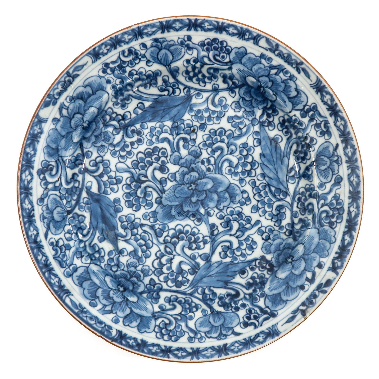A Blue and White Plate: Floral decor, 18th Century, 27 cm. in diameter, chip.