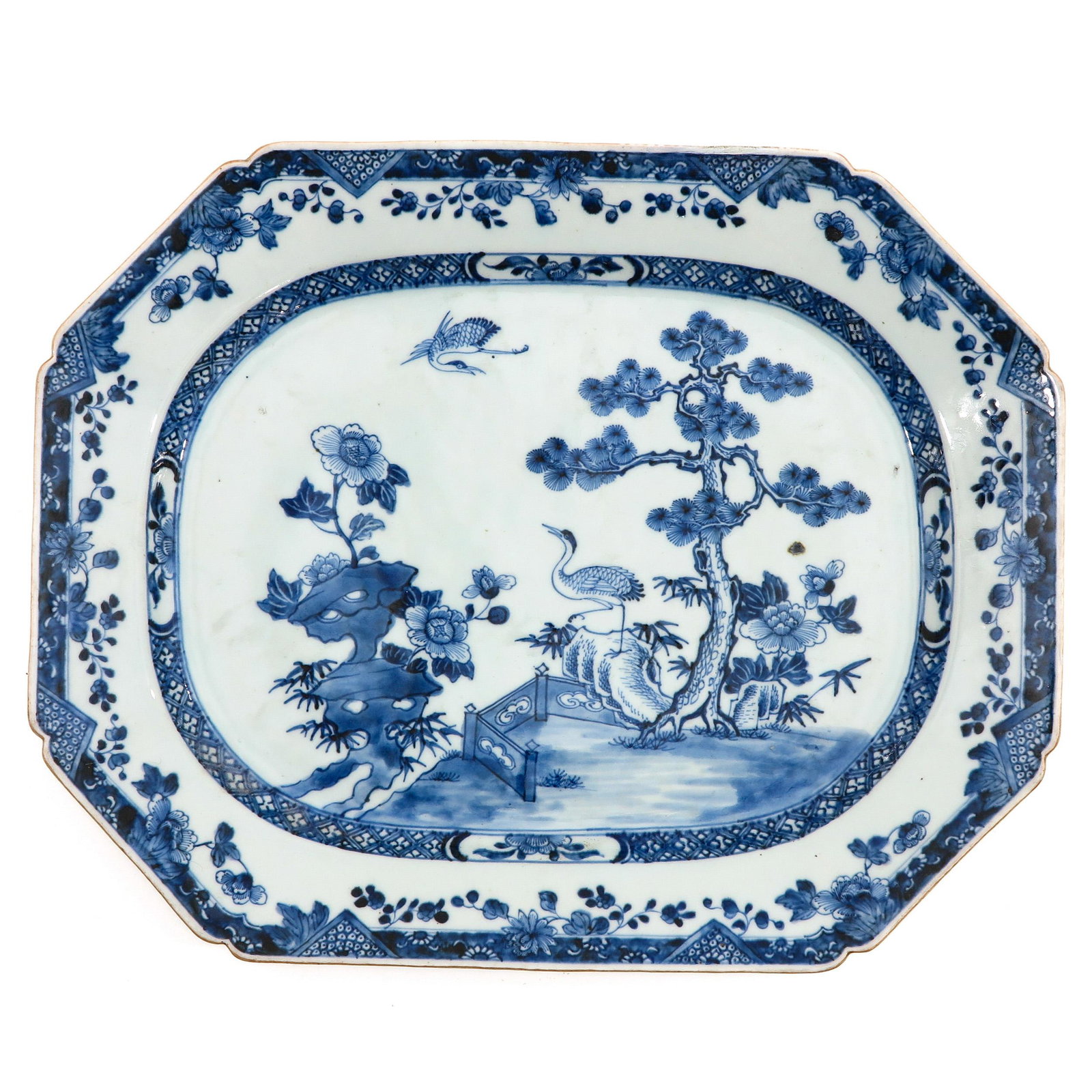 A Blue and White Charger: Depicting scene in garden with bird, circa 1800, 41 x 33 cm.