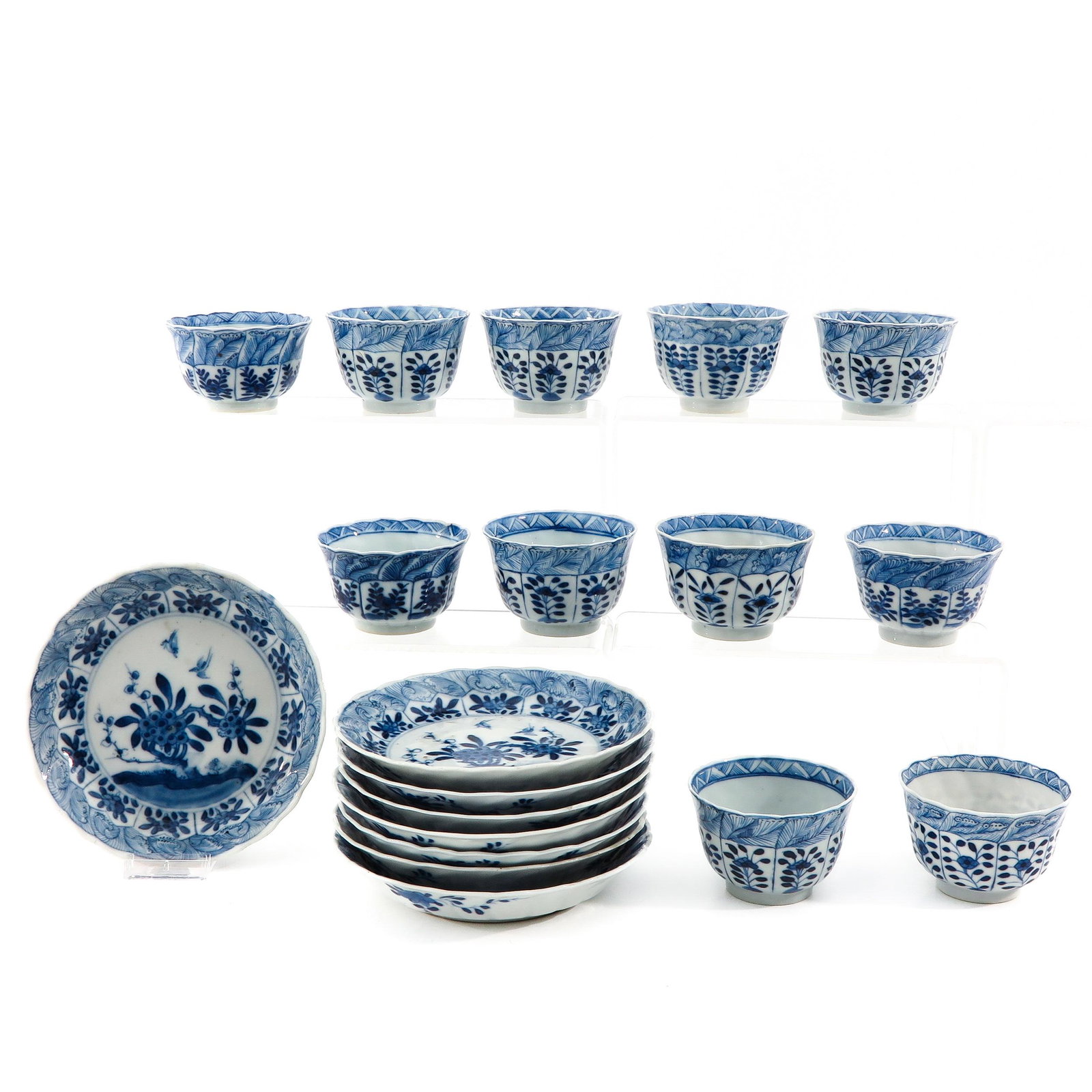 A Collection of Cups and Saucers: Including 11 cups and 8 saucers in floral decor, depicting flowers in garden, saucers are 15 cm. in diameter, in diverse conditions.