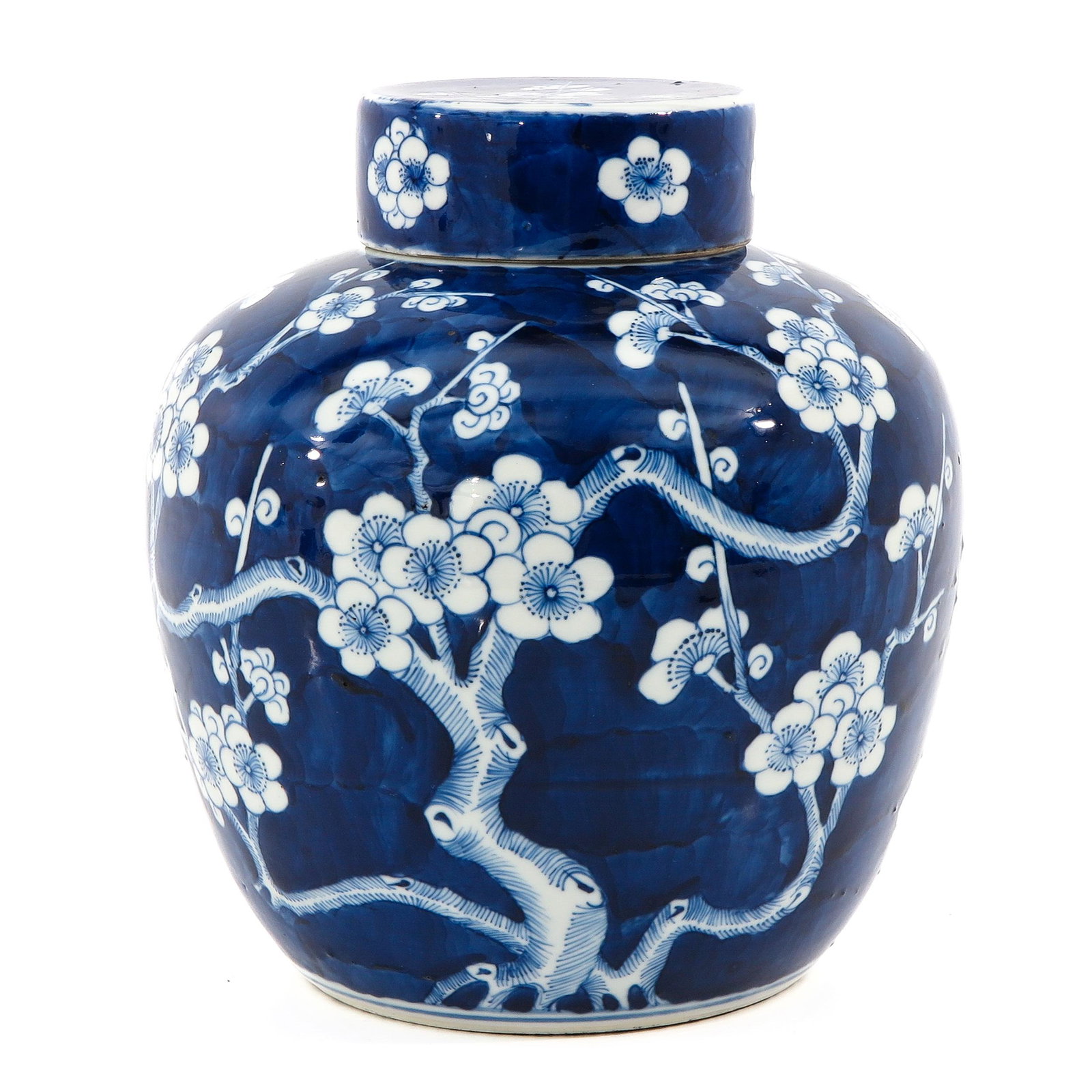 A Blue and White Ginger Jar: Dark blue ground with white flower blossom decor, 25 cm. tall.