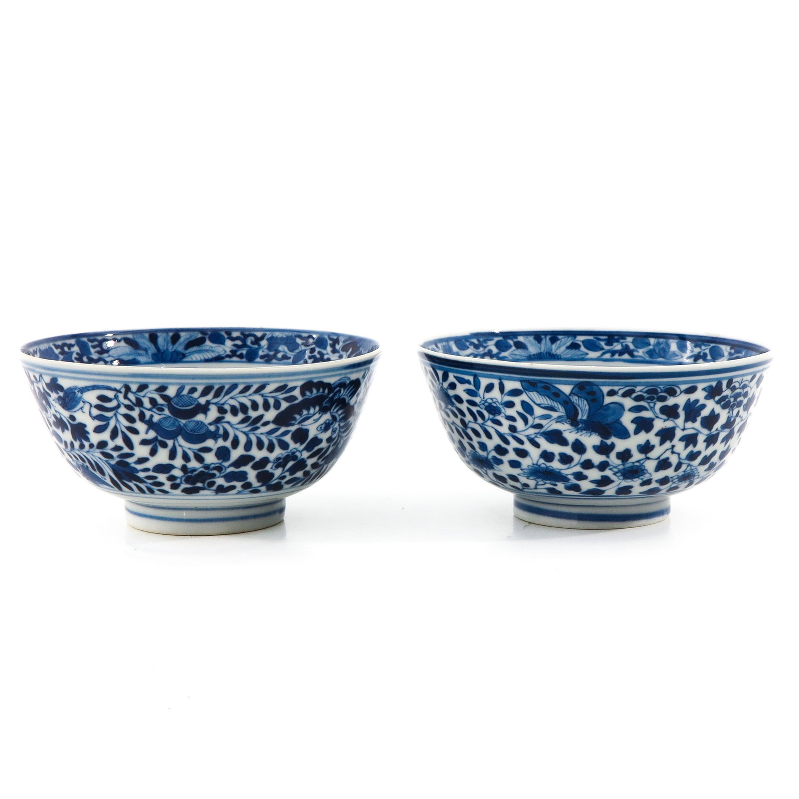 A Pair of Blue and White Bowls: Decorated with flowers, butterflies, and birds with dragon in center of bowl, 12 cm. in diameter.