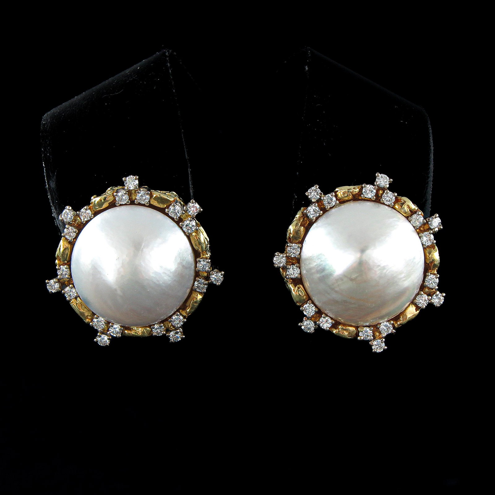 An Pair of 18KG Diamond and Pearl Earrings: Each set with 21 brilliant cut diamonds and pearl, 28 mm. in diameter.