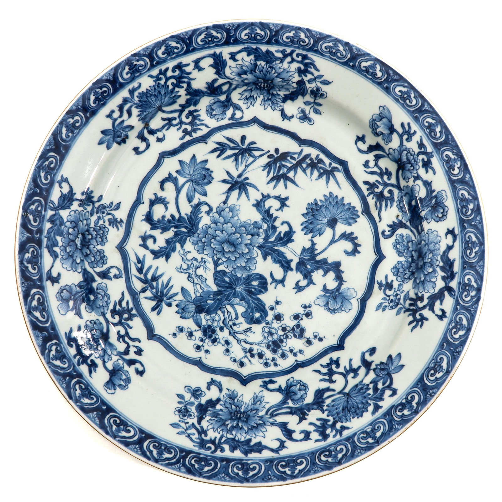 A Blue and White Charger: Decorated with flowers and bamboo, 18th Century, 34 cm. in diameter,