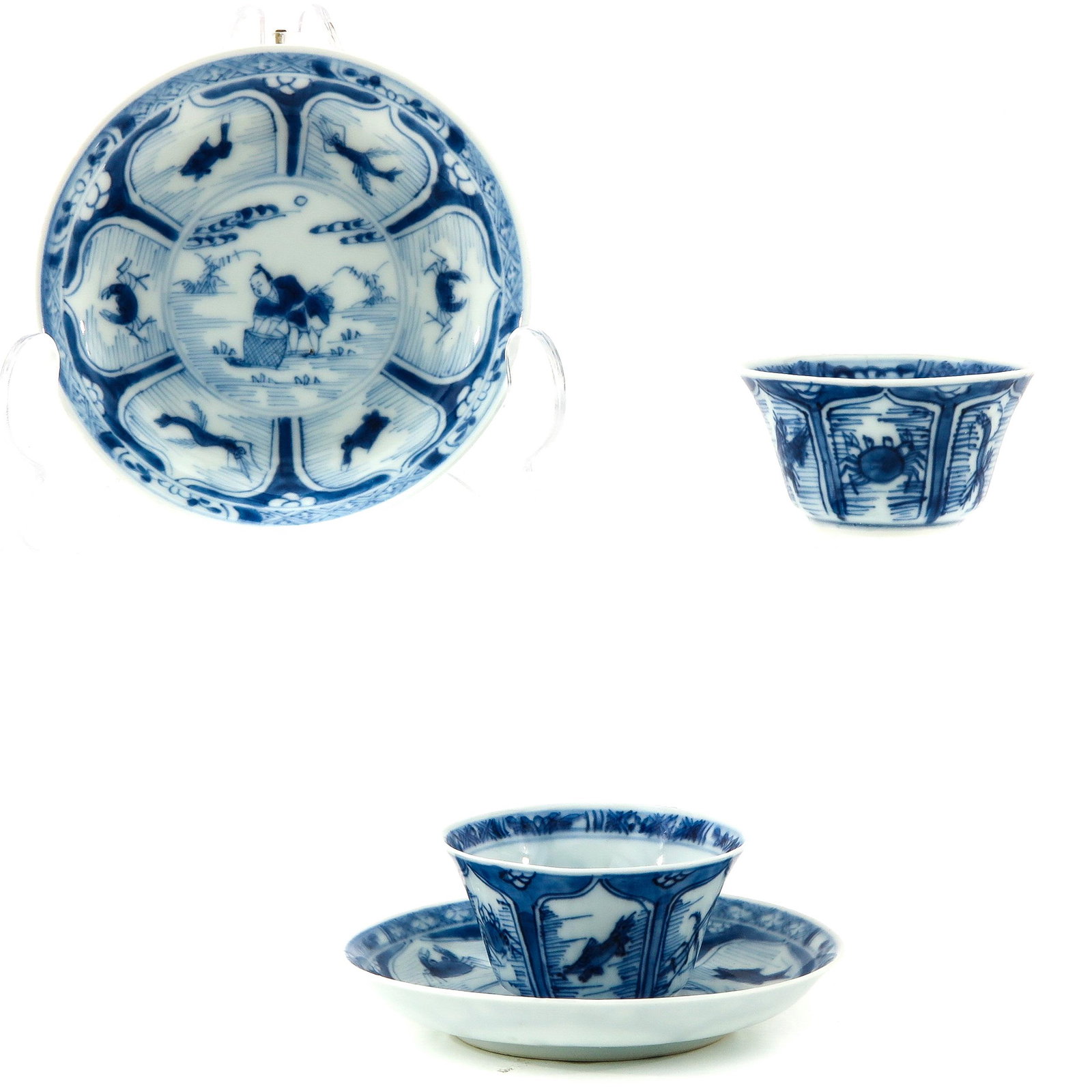 A Pair of Blue and White Cups and Saucers: Depicting fisherman in center of saucer with sea creatures on border, saucers measure 10 cm. in diameter.