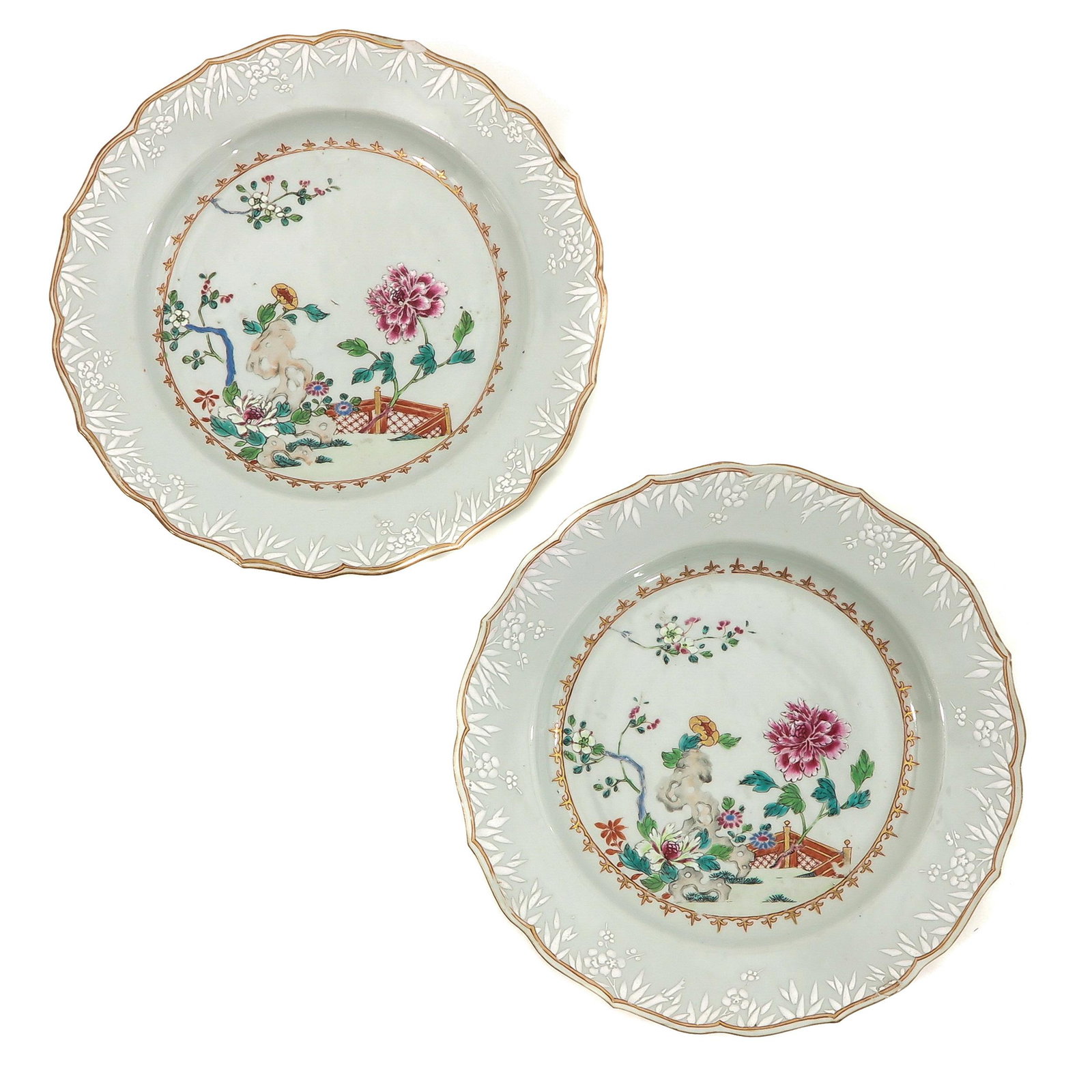 A Pair of Famille Rose Chargers: Depicting scene in garden with peonies and flowers, 18th Century, 32 cm. in diameter, chip.