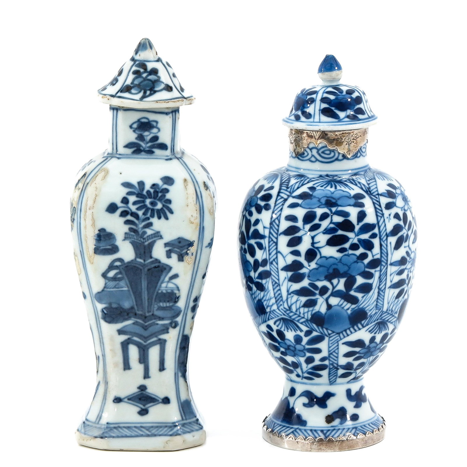 A Lot of 2 Blue and White Garniture Vases: Decorated with flowers and Chinese Antiquities, 18th Century, measuring 17 and 18 cm. tall, small parts of glaze missing.