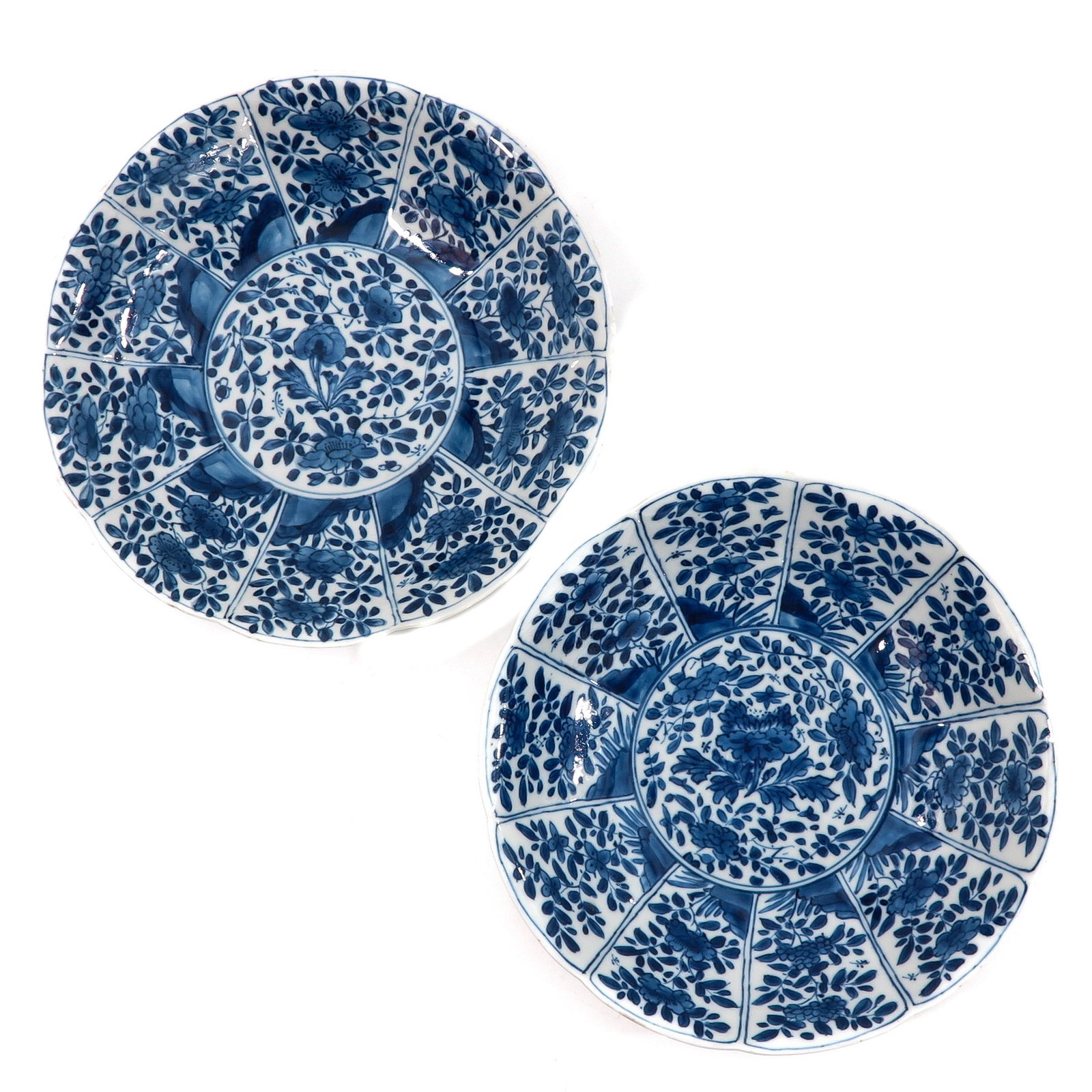 A Pair of Blue and White Plates: Floral decor, marked with double ring and flower, 21 cm. in diameter, chip.