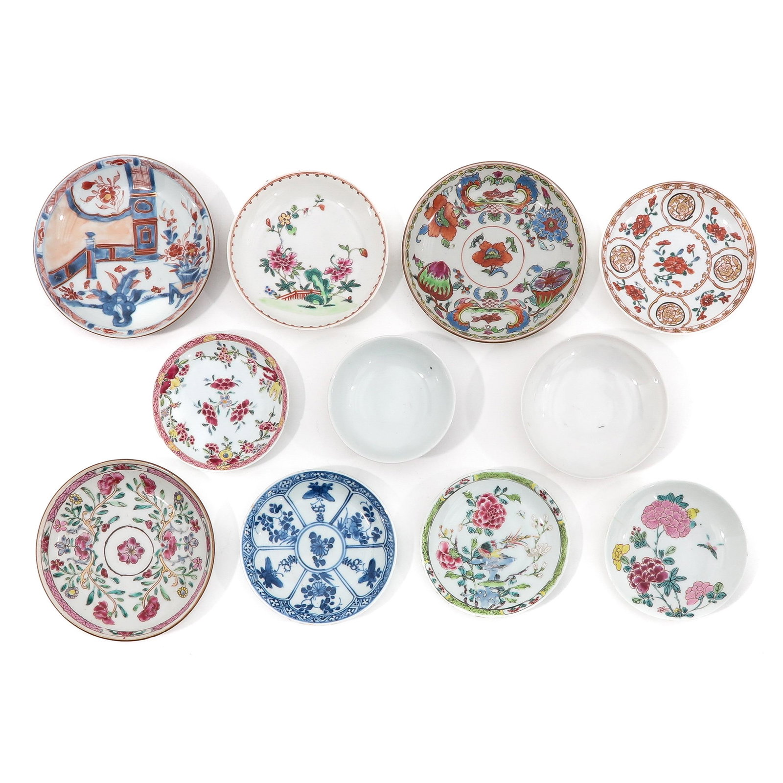 A Collection of Saucers and Covers: Including 9 saucers and 2 covers, in a variety of decors and sizes, including 18th Century, largest saucer is 14 cm. in diameter, chip and hairline.