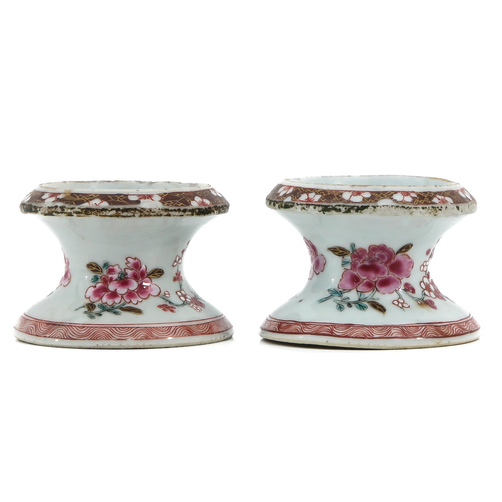 A Pair of Famille Rose Salt Cellars: Floral decor, circa 1800, 8 cm. in diameter, fritting.