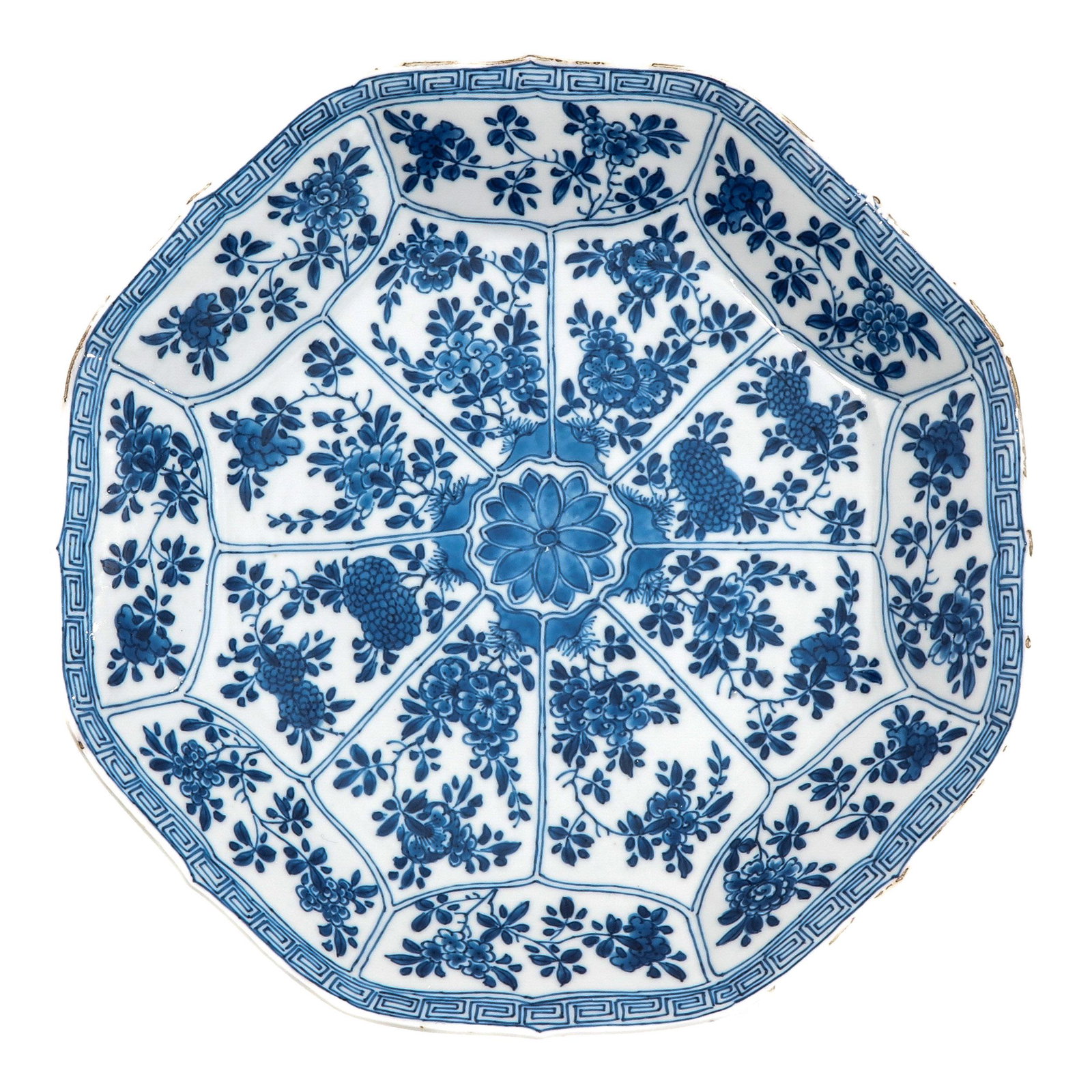 A Blue and White Plate: Floral decor, 18th Century, marked with double ring and flower, 26 cm. in diameter, chip.