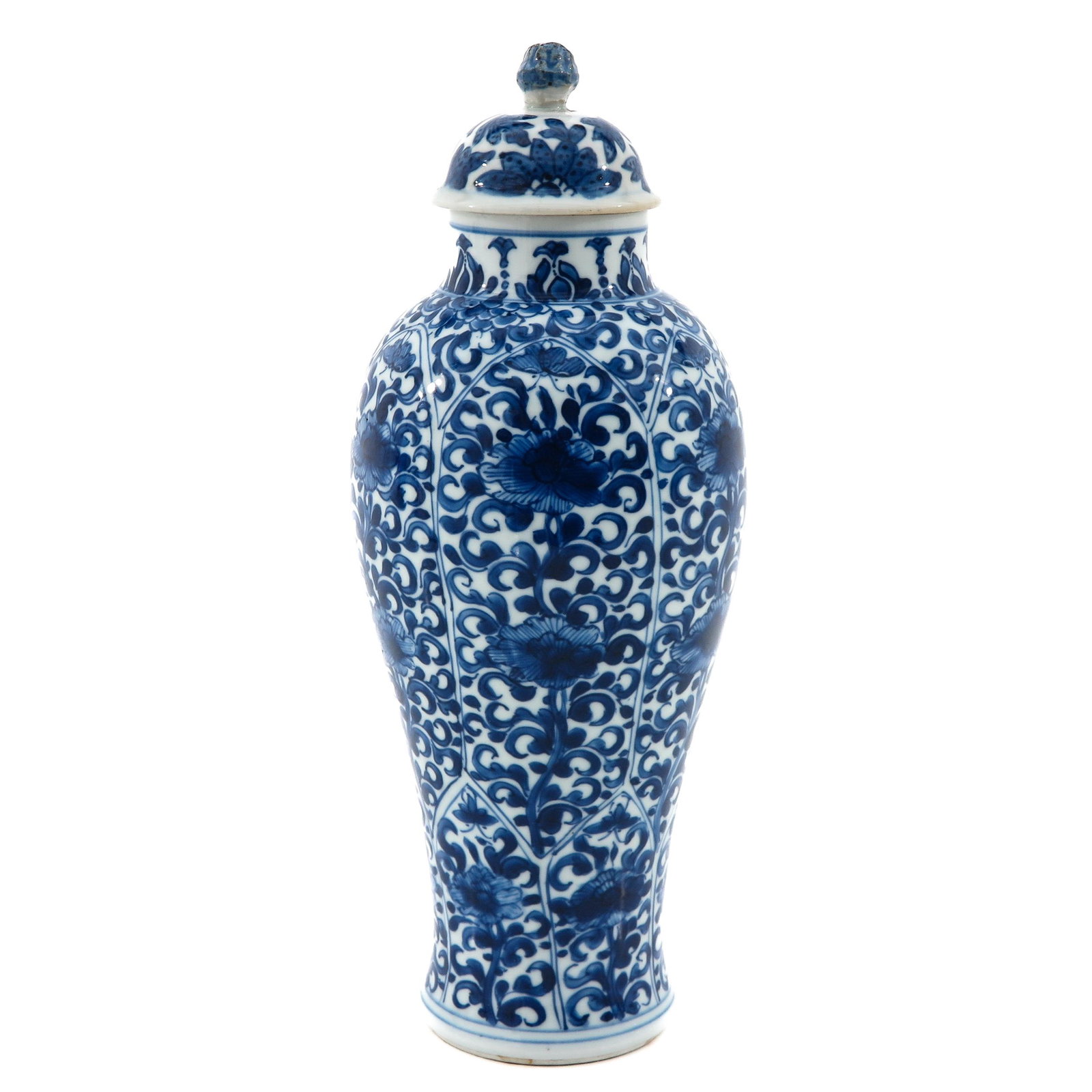 A Blue and White Garniture Vase: Decorated with flowers, Kangxi Period, 28 cm. tall, top is restored.