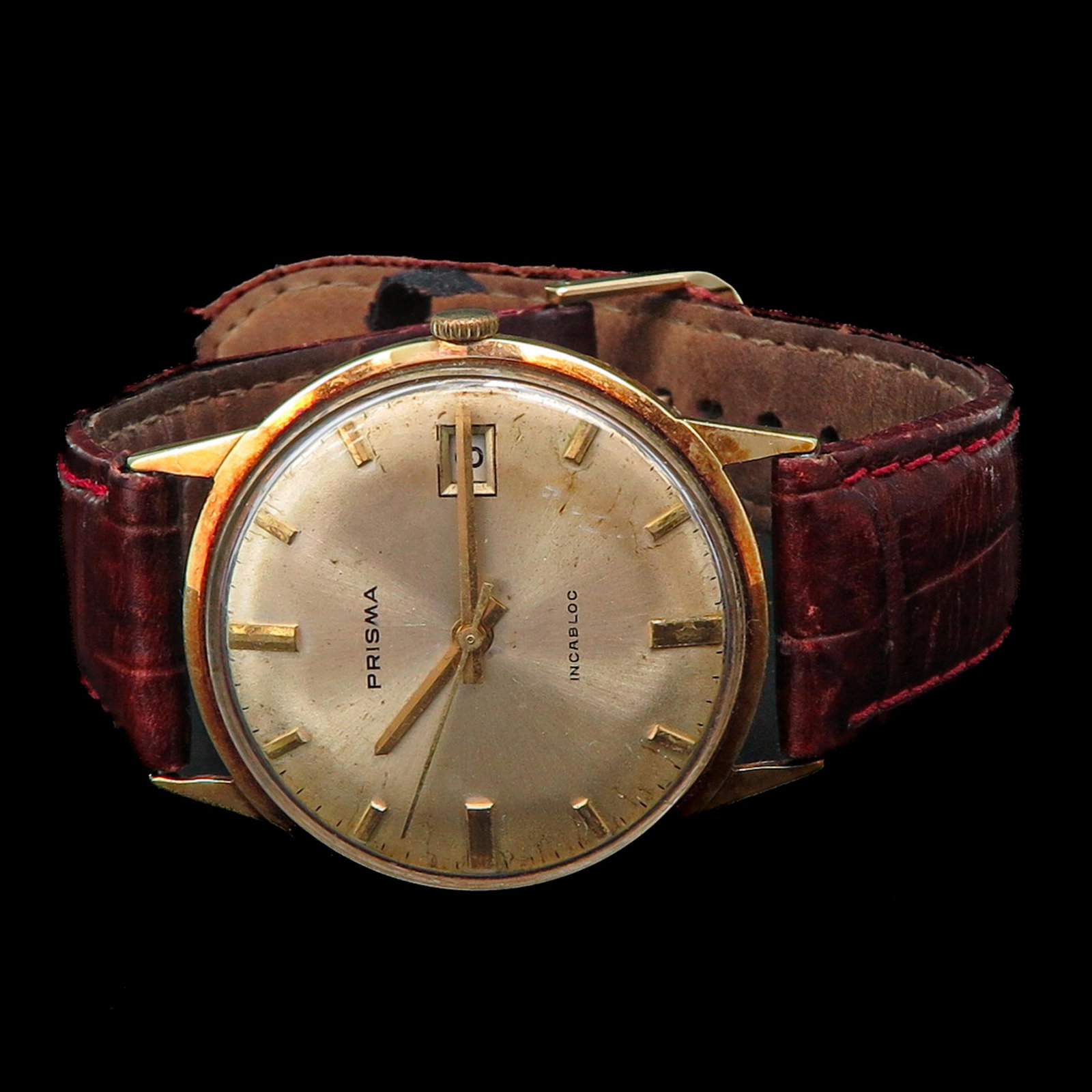 A Mens Prisma 14KG Watch: Incabloc, case is 33 mm. in diameter, with leather band.