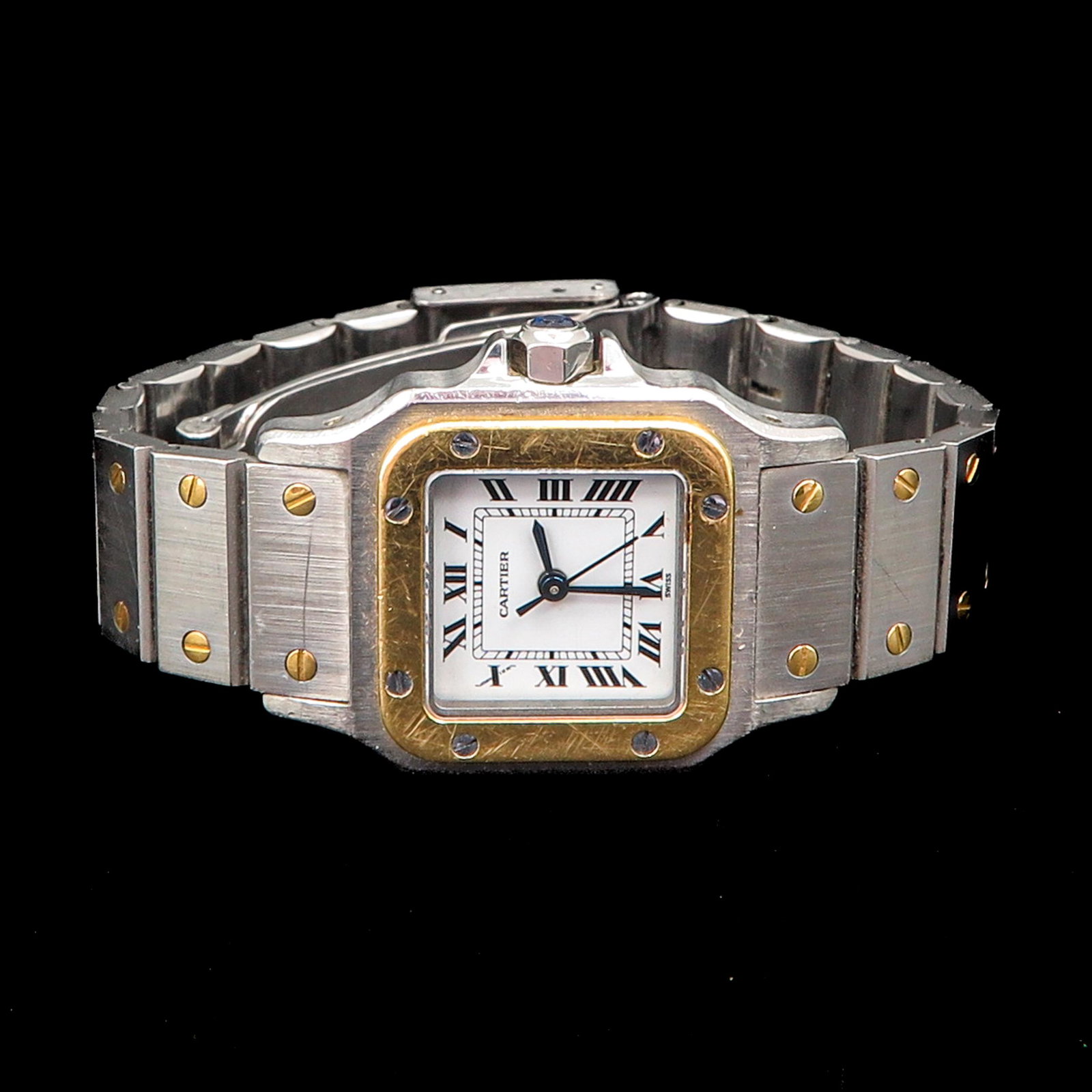 A Ladies Cartier Watch: Santos model, gold on steel, case is 24 mm. in diameter.
