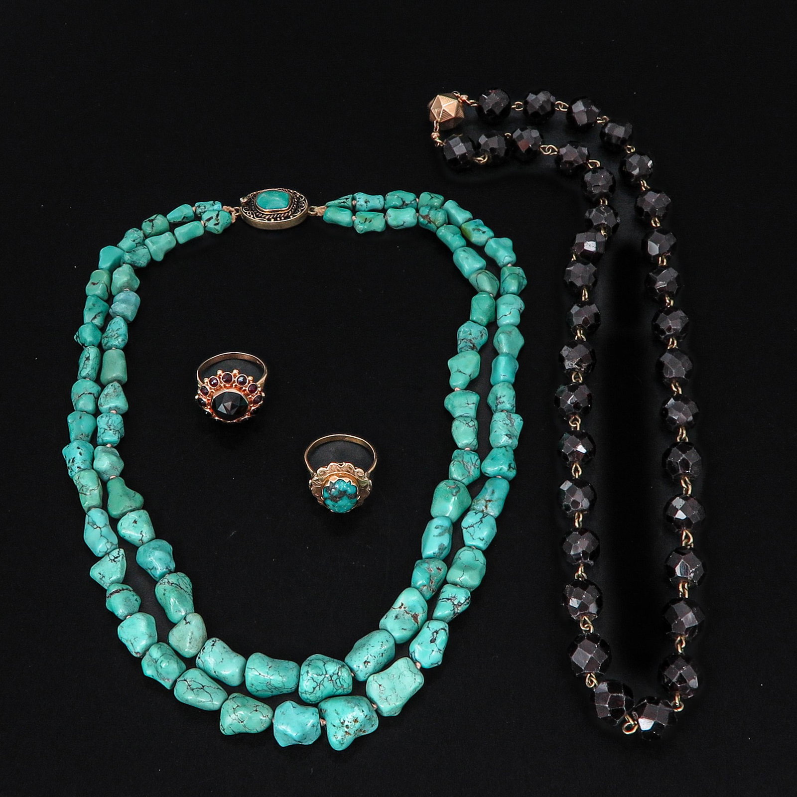 A Turquoise Necklace and Ring along with a Garnet Necklace and Ring: Ring are 14KG, largest size ring is 18.