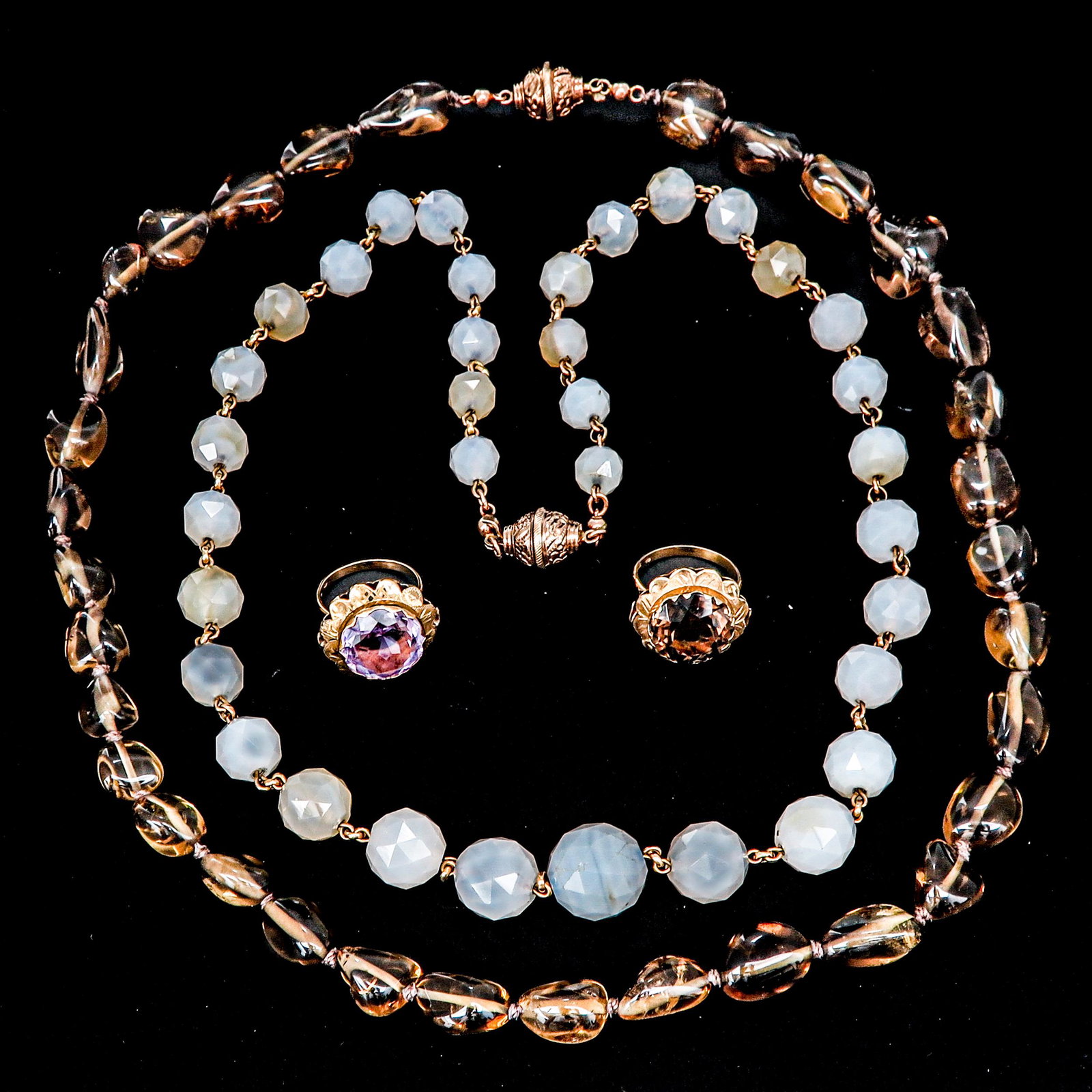 A Collection of Jewelry: Including Amethyst and Topaz rings size 18 and 2 necklaces 60 cm. long.