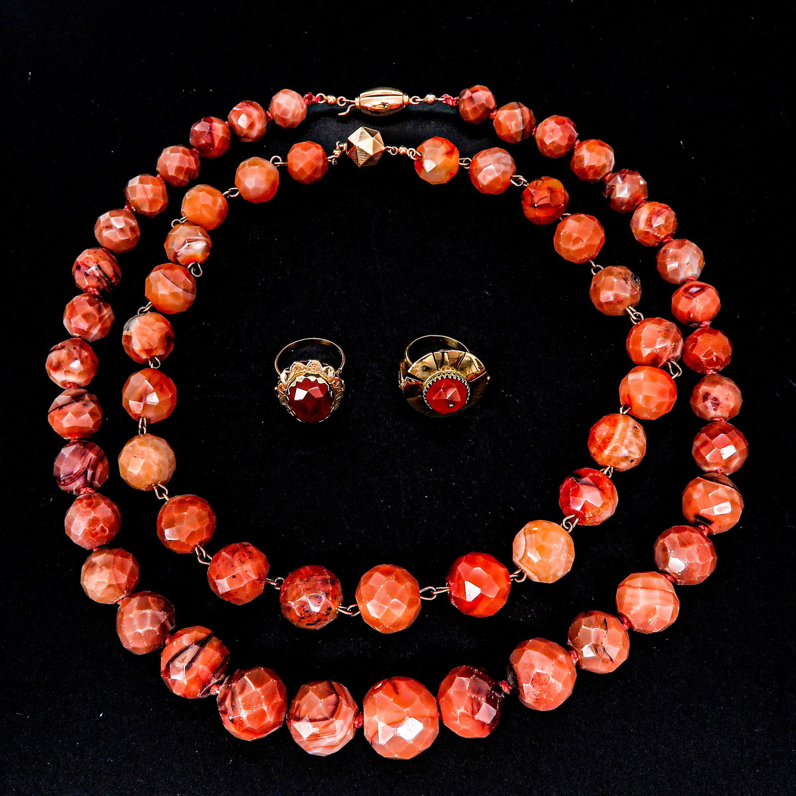 A Collection of Jewelry: Including 2 necklaces and 2 14KG rings met faceted carnelian, largest ring size is 17.