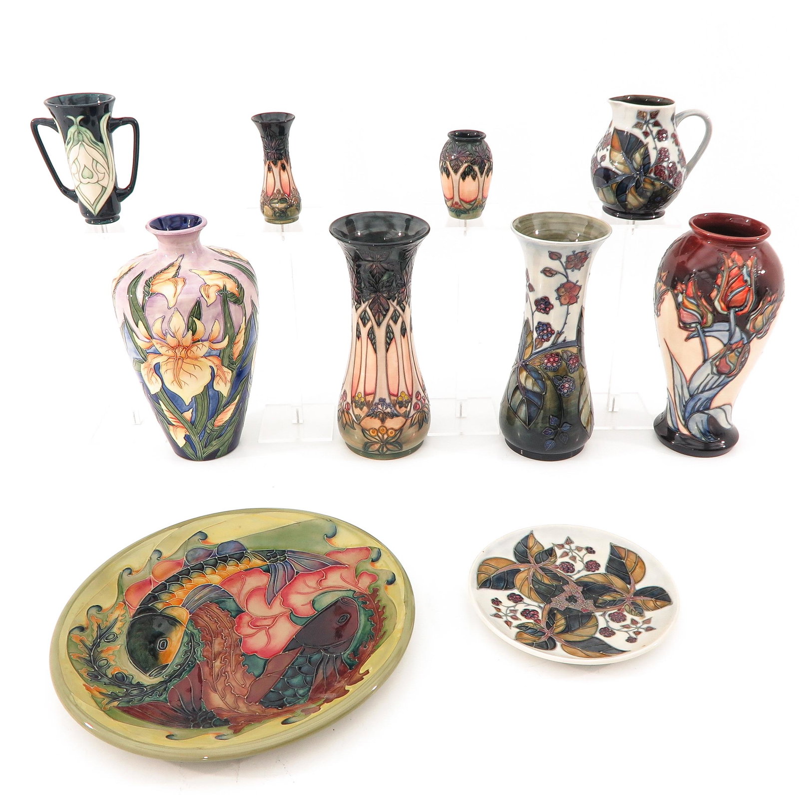A Collection of Pottery: 10 pieces, marked Moorcroft, tallest vase is 31 cm.
