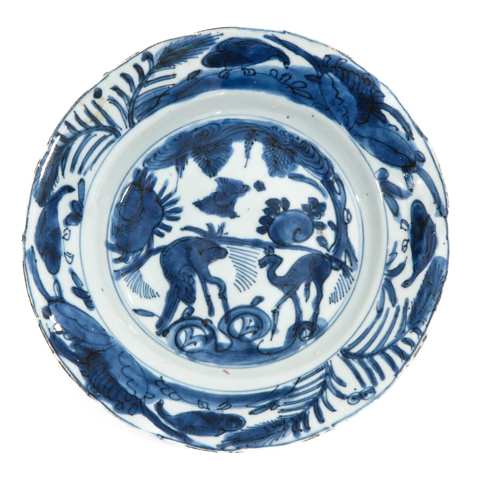 A Ming Plate: Depicting deer in garden, 21 cm. in diameter, chip.