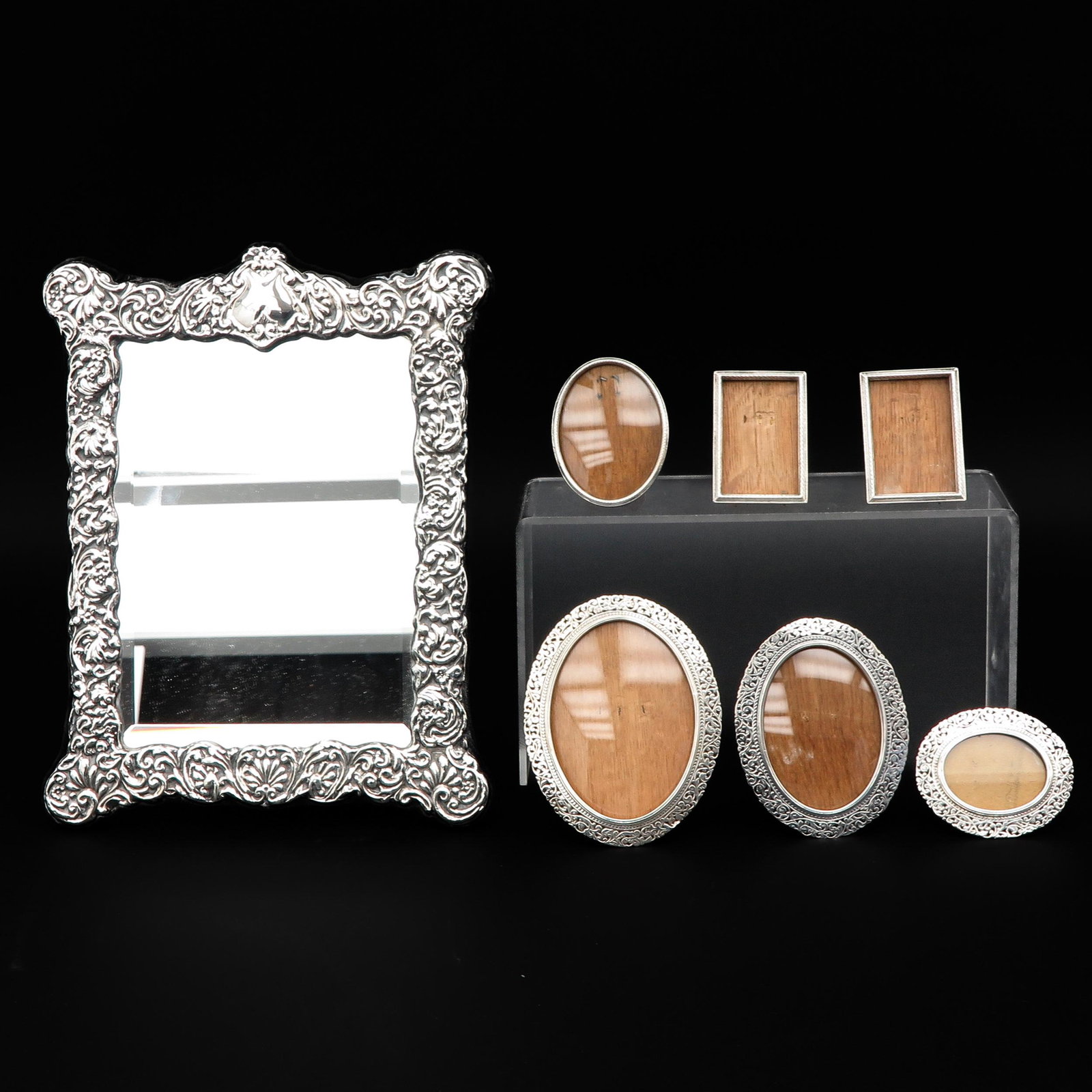 A Collection of 7 Photo Frames: Including silver, largest is 23 x 30 cm.