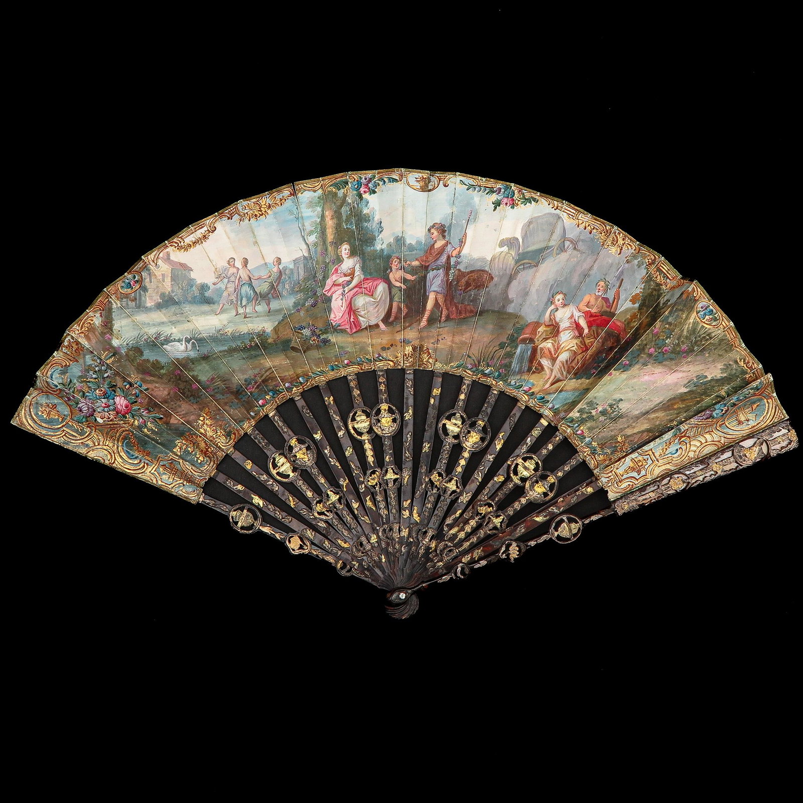 An 18th Century Dutch Fan: Holland, 18th century, painted depiction of a romantic scene in a garden, with tortoiseshell ribs, width 47 cm. This lot will not be shipped outside the EU.