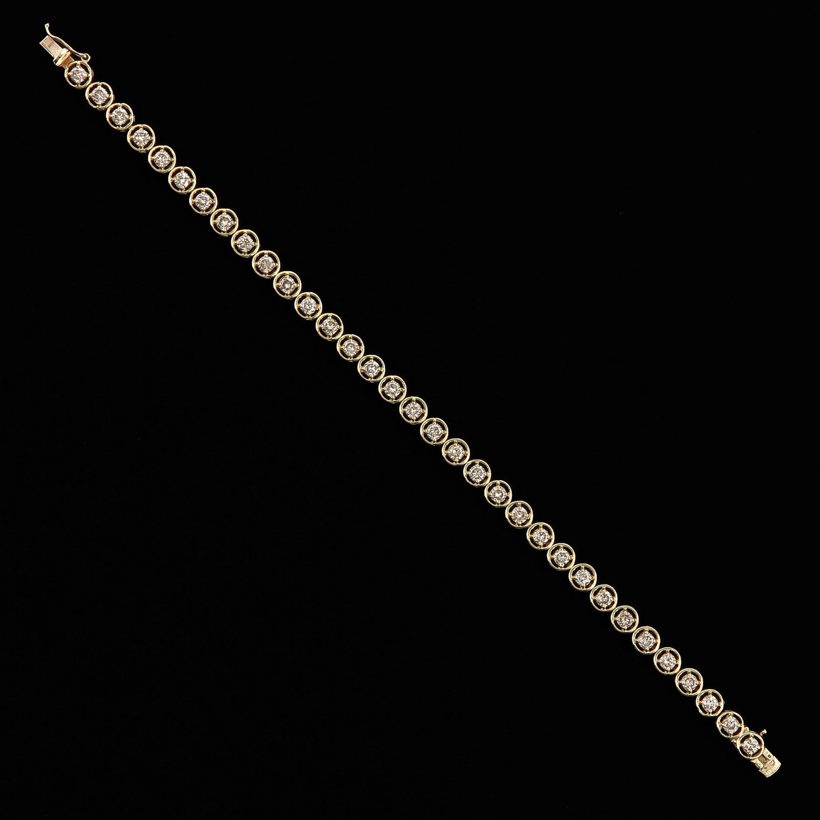 A 14KG Diamond Tennis Bracelet: 20 cm. long with 34 diamonds.