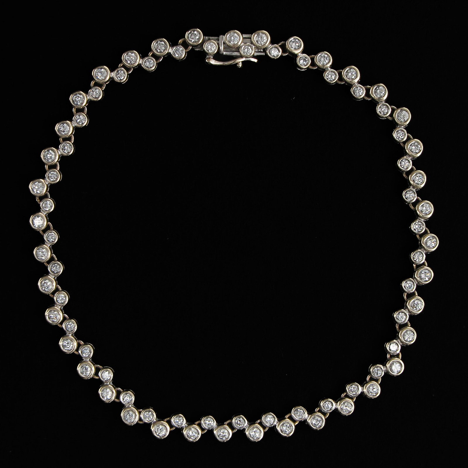 A 14KG Diamond Tennis Bracelet: Set with 78 diamonds, 20 cm. long.