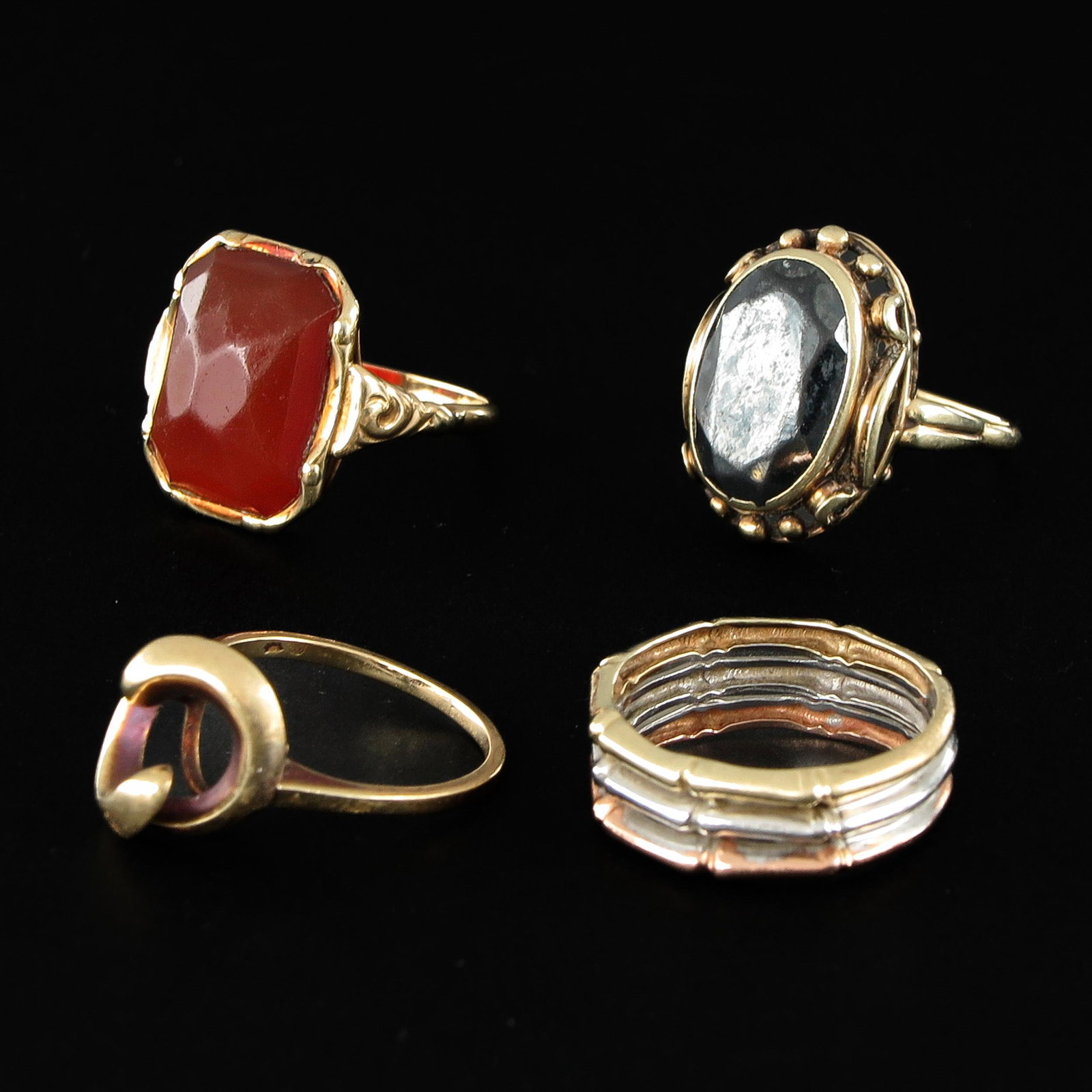 A Collection of 14KG Ladies Rings: 4 rings, including ring set with Carnelian, ring size 17 - 18.