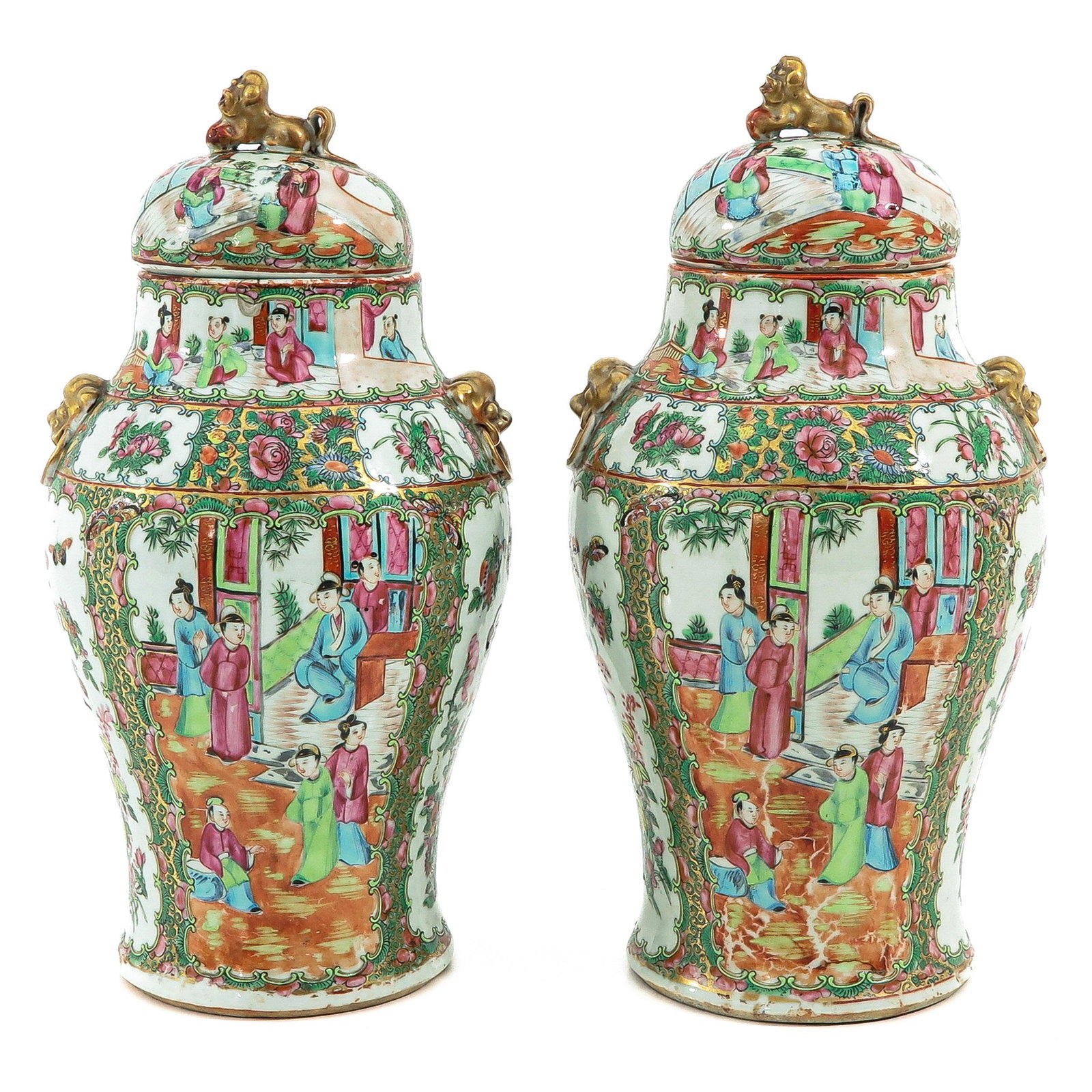 A Pair of Cantonese Vases with Covers: Decorated with Chinese figures, flowers, and butterflies, with temple lions on handles, 39 cm. tall, one vase is restored.