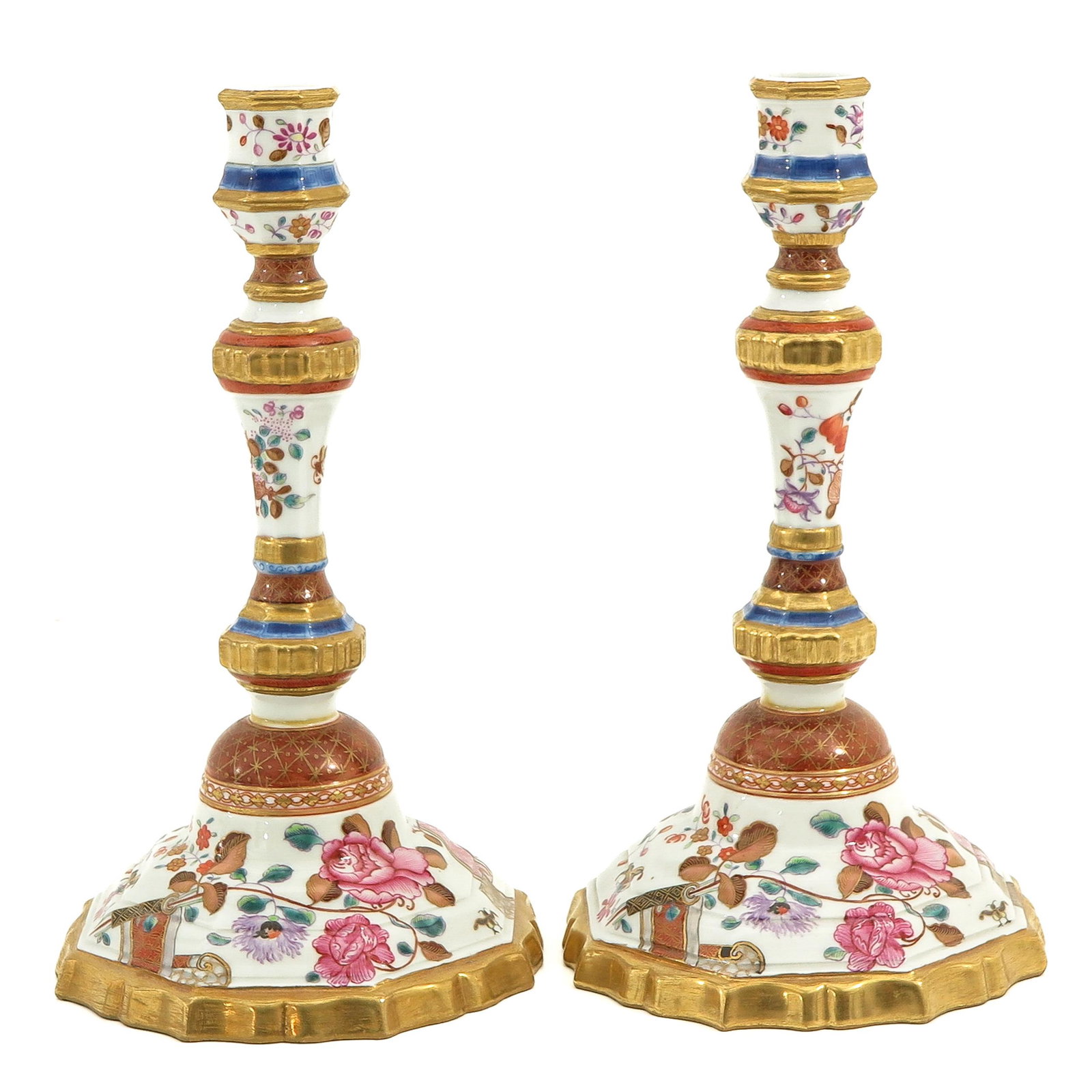 A Pair of Famille Rose Candlesticks: Floral decor, 25 cm. tall, both restored.