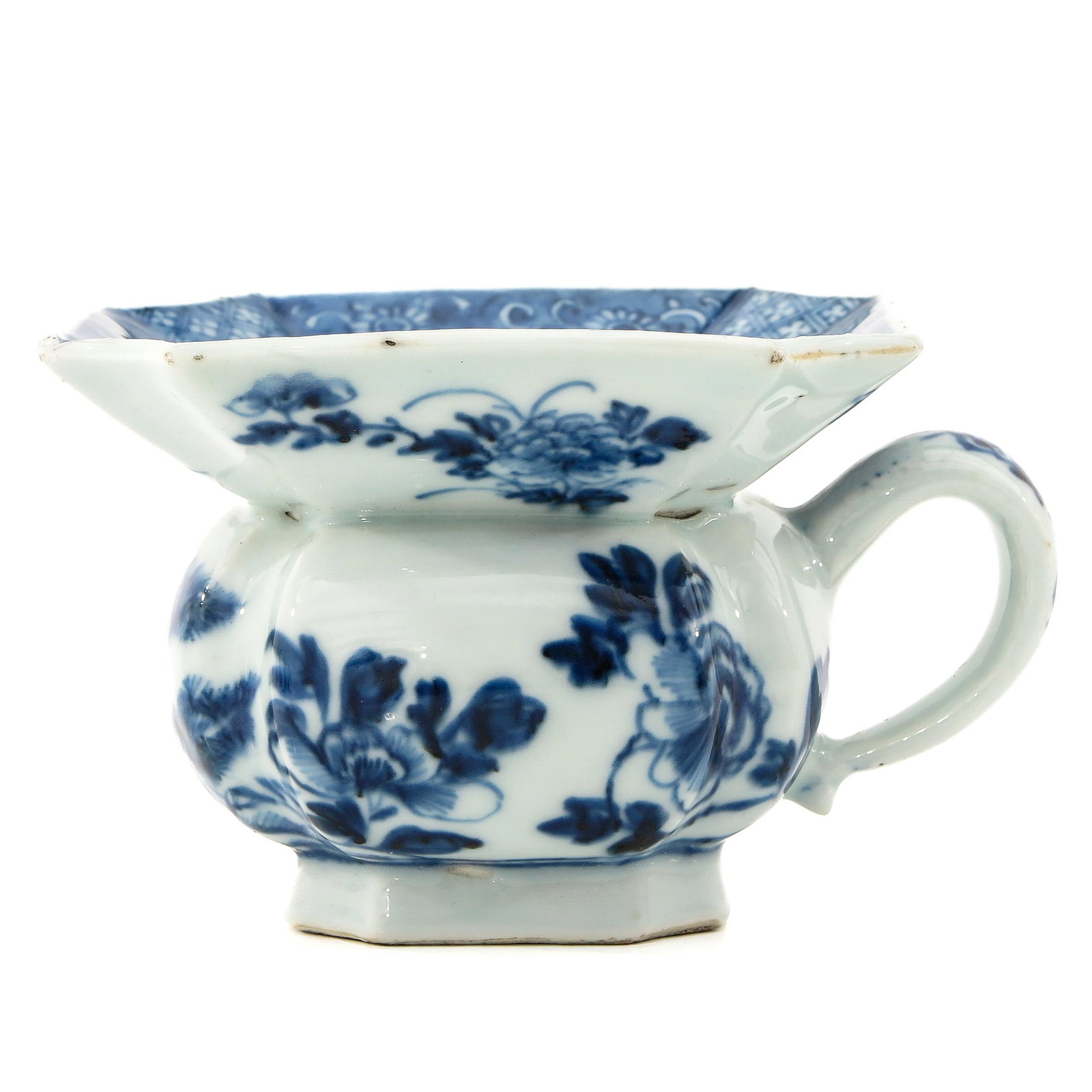 A Blue and White Spittoon: Depicting scene in garden with flowers, circa 1800, 8 cm. tall, chip.