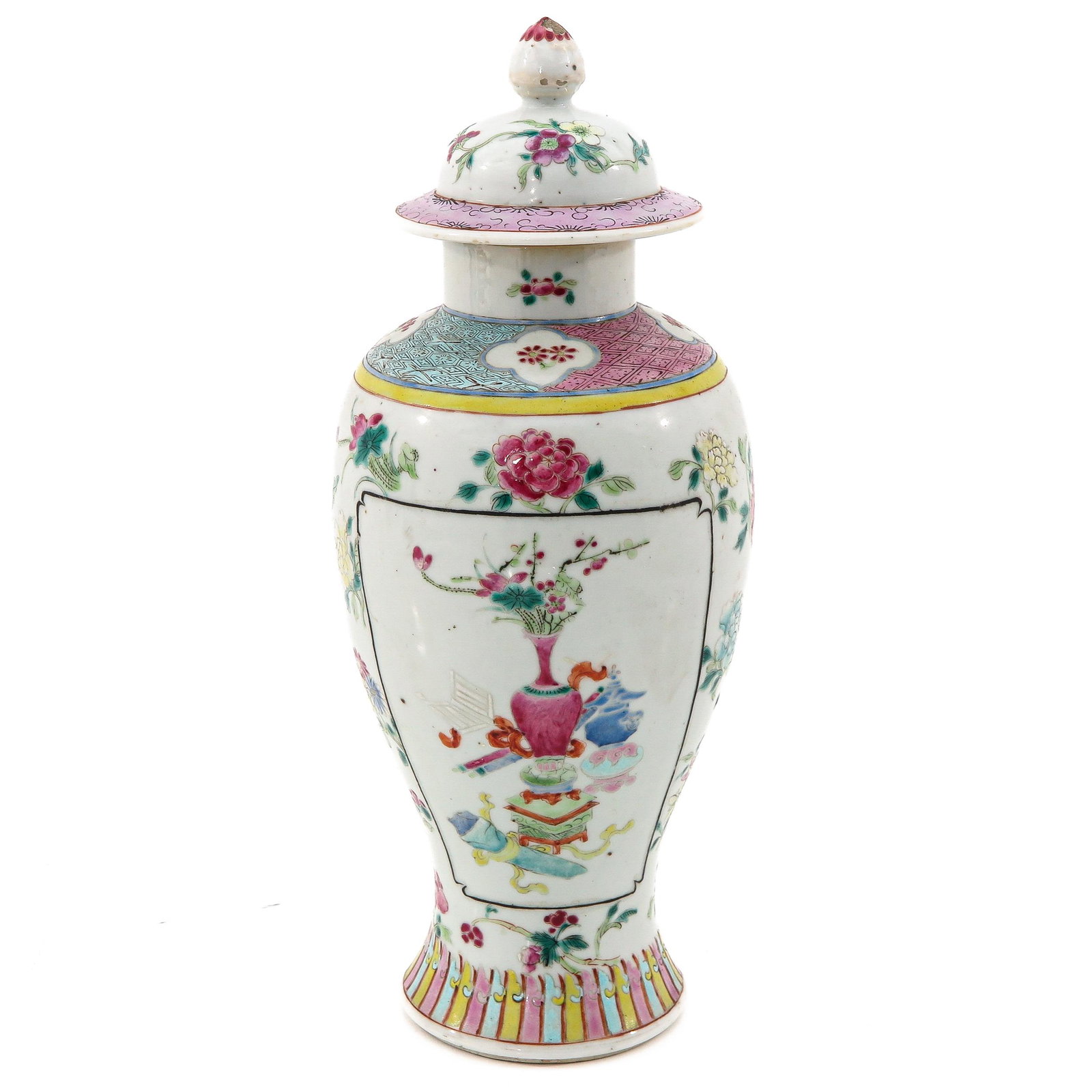 A Famille Rose Garniture Vase: Decorated with flowers and Chinese antiquities, 31 cm. tall, small part of glaze missing on cover.