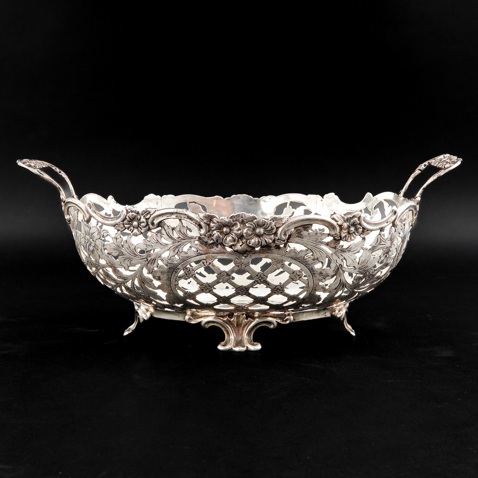 A Silver Basket: Maker's mark Eldik, Zutphen, with floral decorations, width 33 cm.