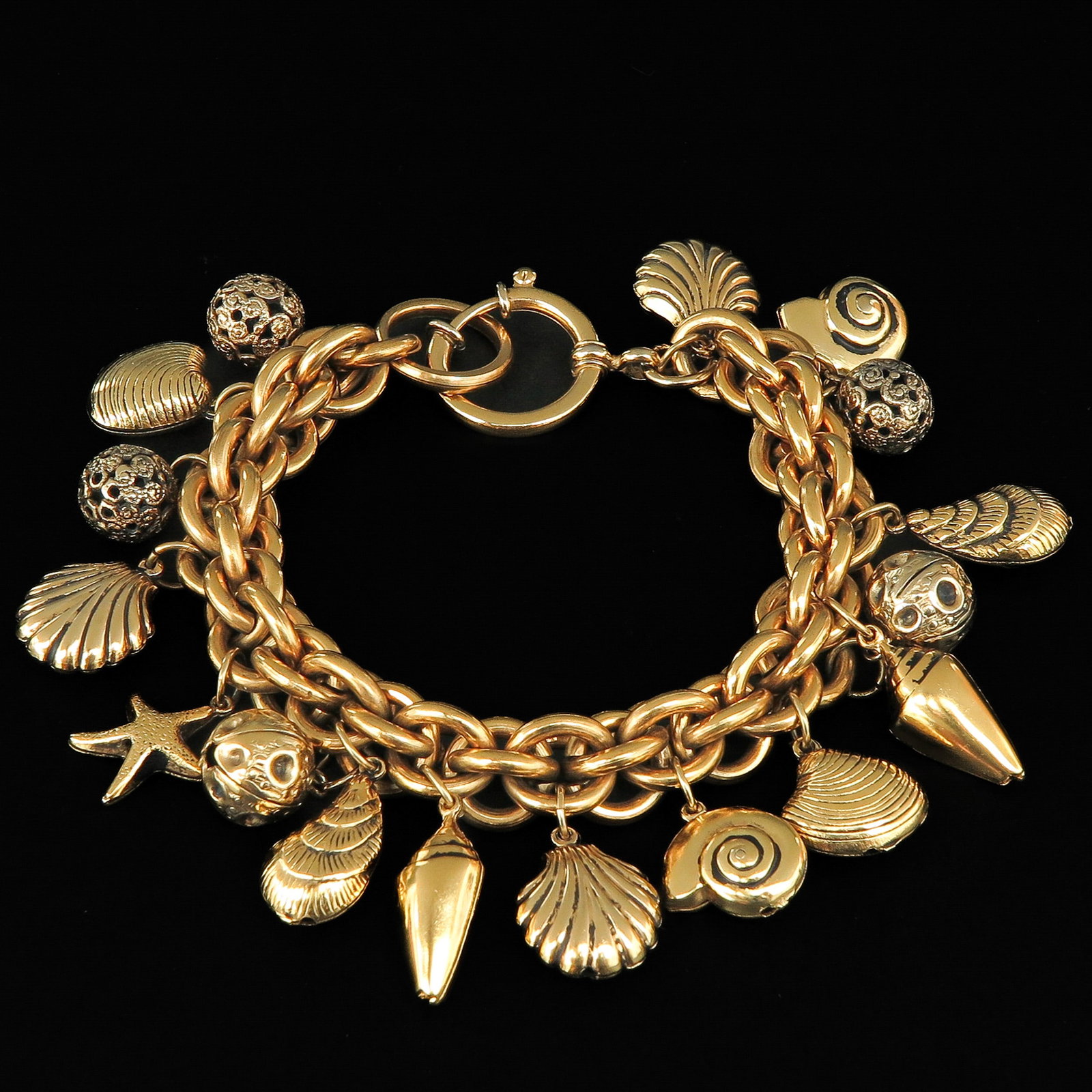 A Charm Bracelet: Holding many charms, 21 cm. long.