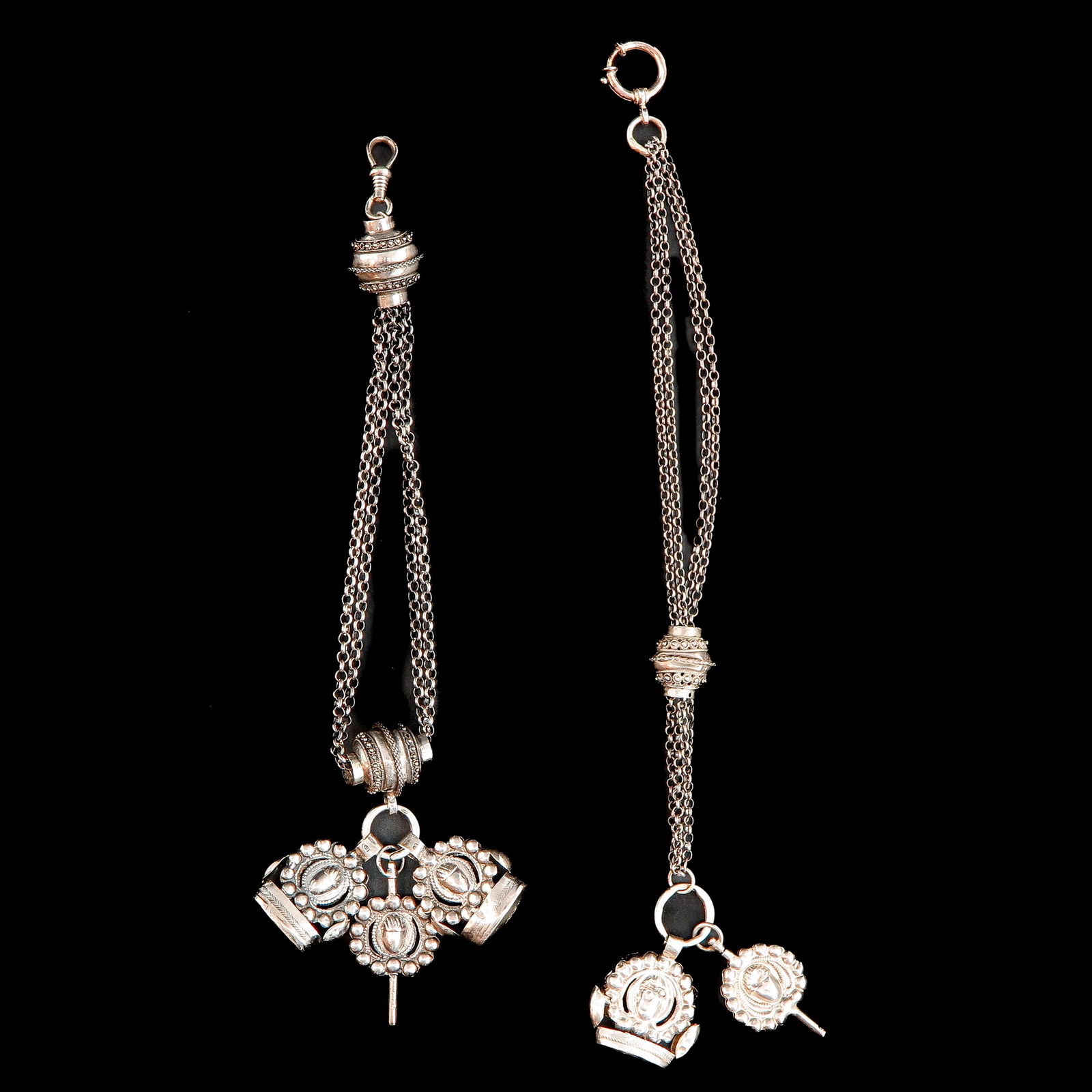 A Lot of 2 Silver Chatelaines: Including watch chain and 2 Jasseron chains with 1 signet and watch key, master mark B Rond, 27 cm. long.