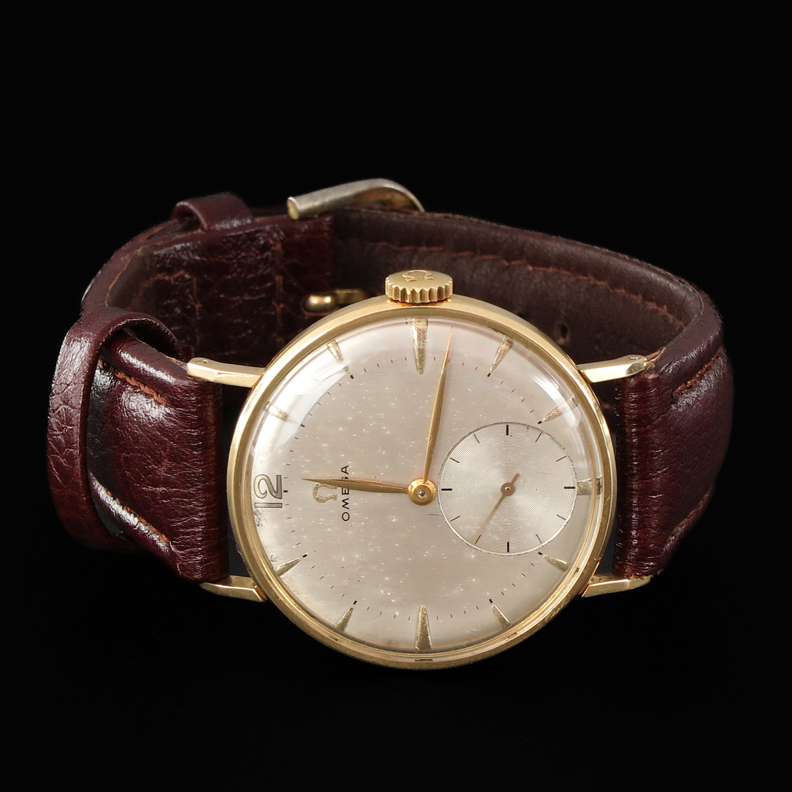 An Omega Watch: Hand winder, 35 mm. in diameter, with leather band.
