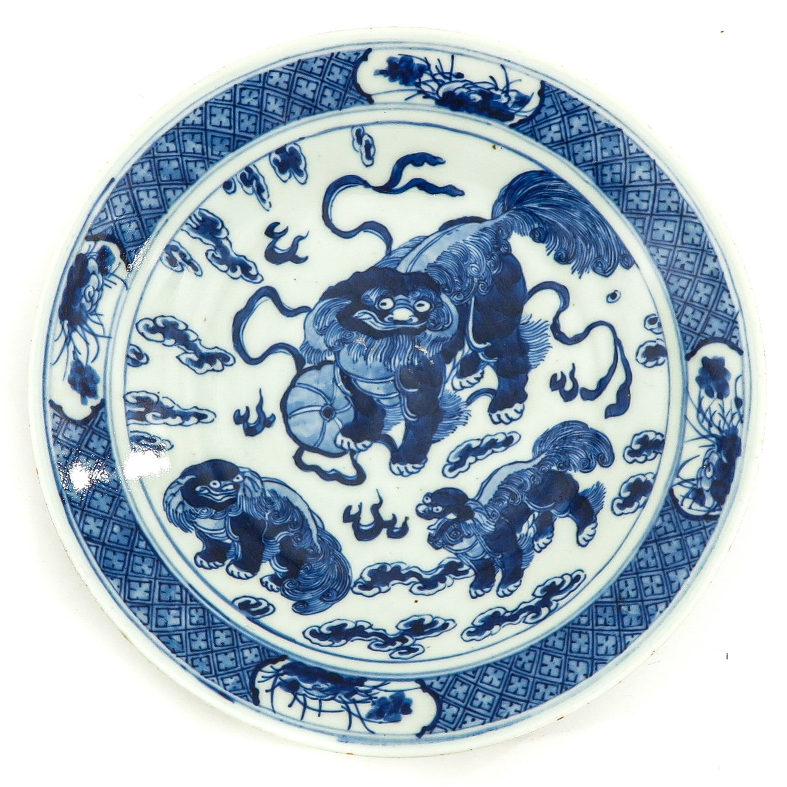 A Blue and White Plate: Decorated with temple lions and clouds, 26 cm. in diameter.