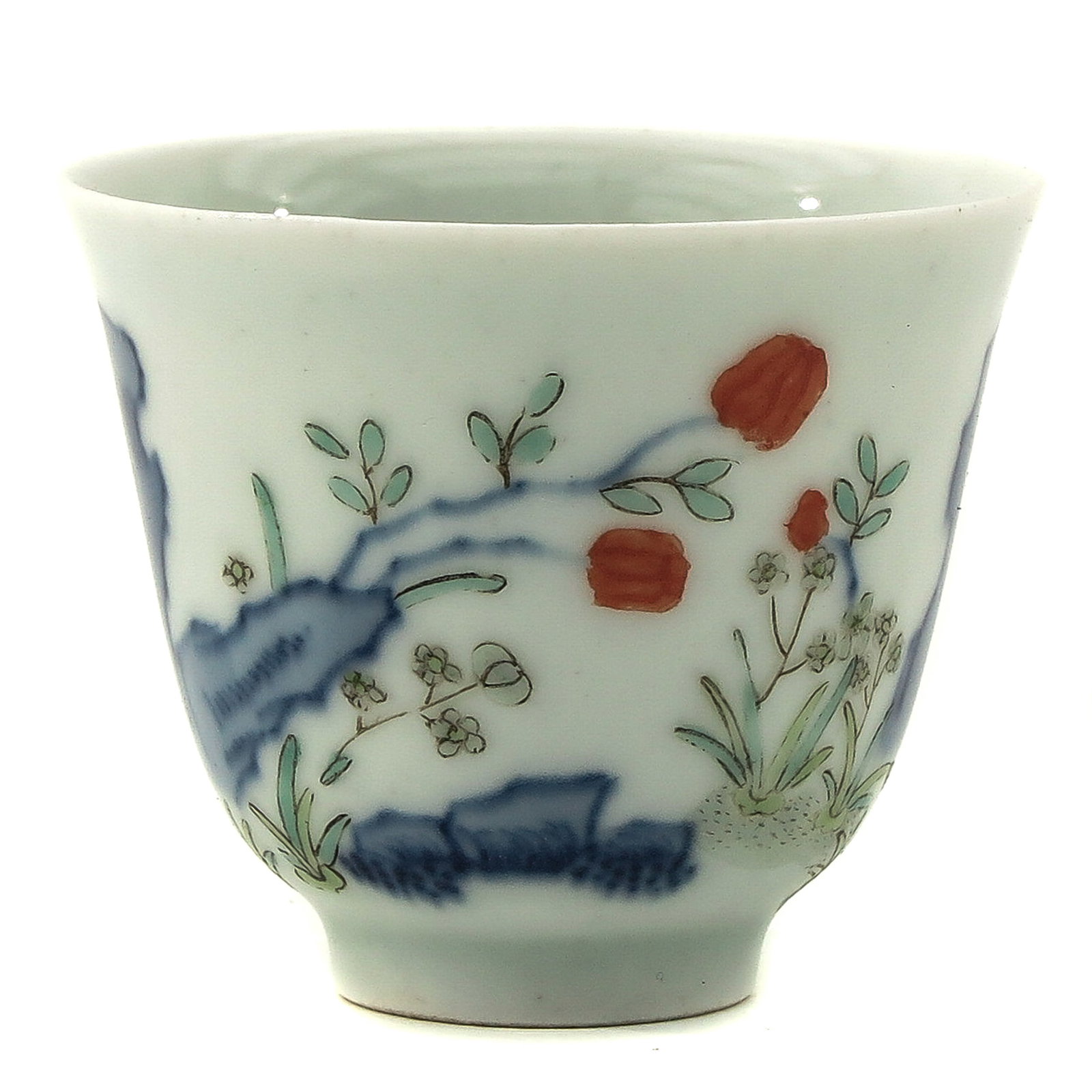A Doucai Decor Cup: Depicting scene in garden with flowers and rocks, Kangxi mark, 5 cm. in diameter.