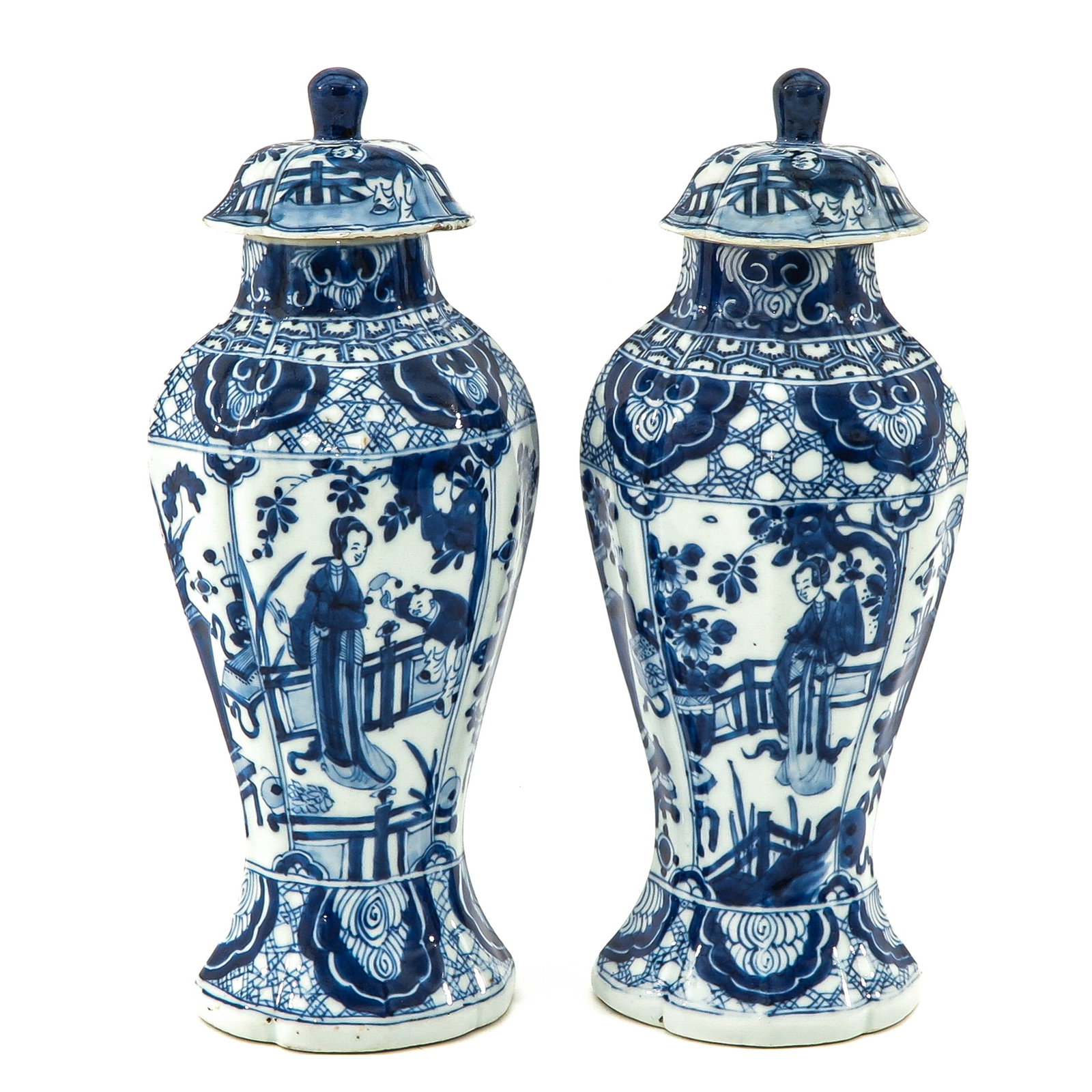 A Pair of Blue and White Garniture Vases: Decorated with alternating scenes of Chinese figures in garden and Chinese Antiquities, 31 cm. tall, covers are restored.