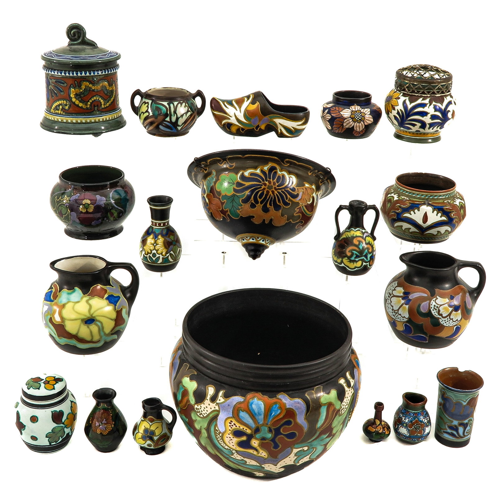 A Collection of Pottery: consisting of 19 pieces of pottery, including a vase marked Rozenburg The Hague and a plant hanger, marked Arnhem Holland, highest 21 cm.