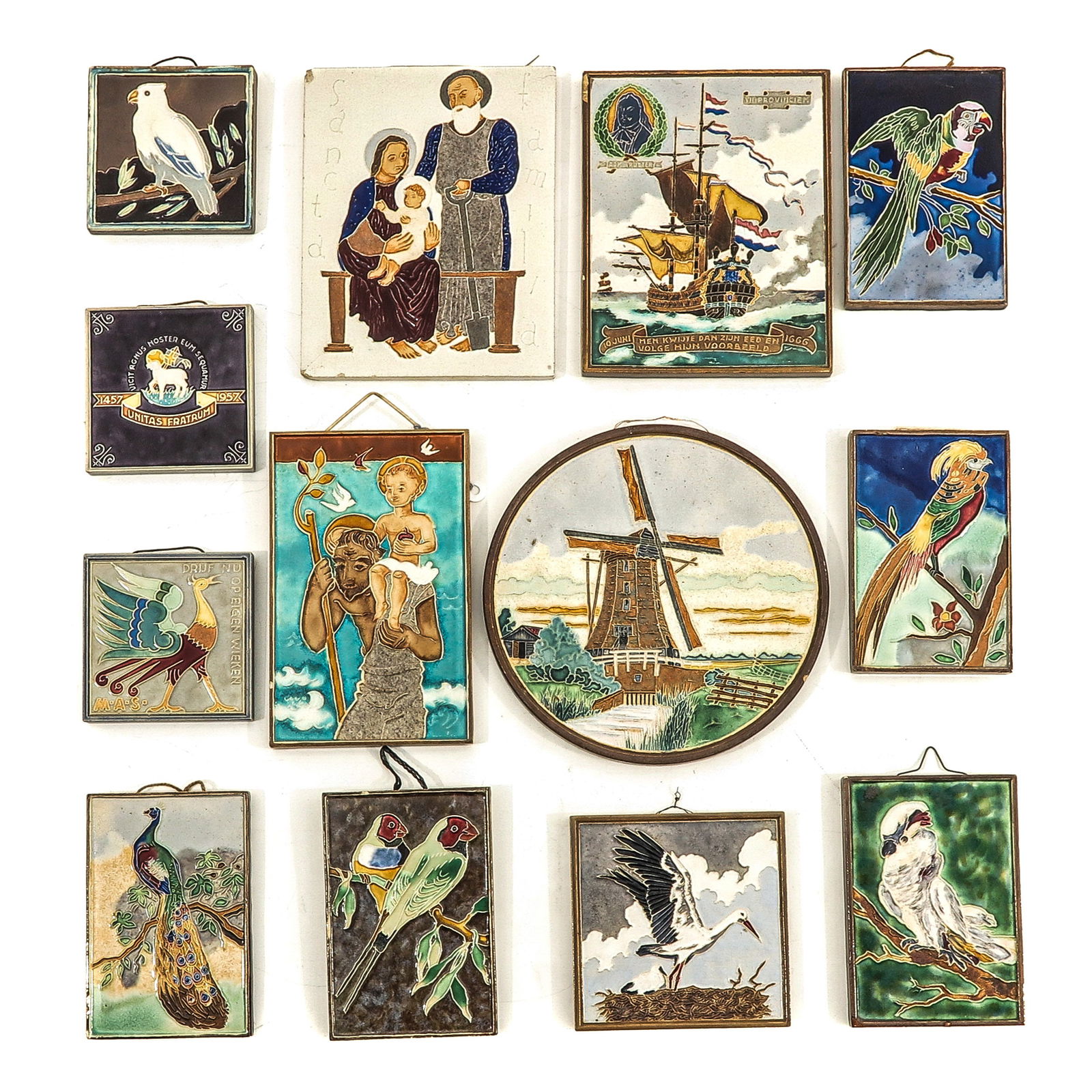 A Collection of 13 Westraven Utrecht Tiles: consisting of 13 cloisonne tiles, marked Westraven Utrecht, including stork and Saint Christopher, largest 16 x 20 cm.