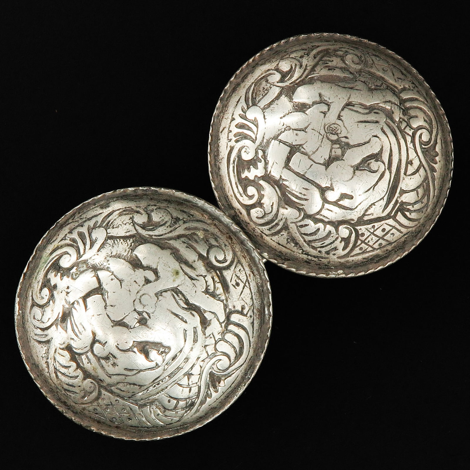 A Pair of 19th Century Silver Broekstukken: Worn in Zeeland traditional costume, with biblical scenes, diameter 60 mm.