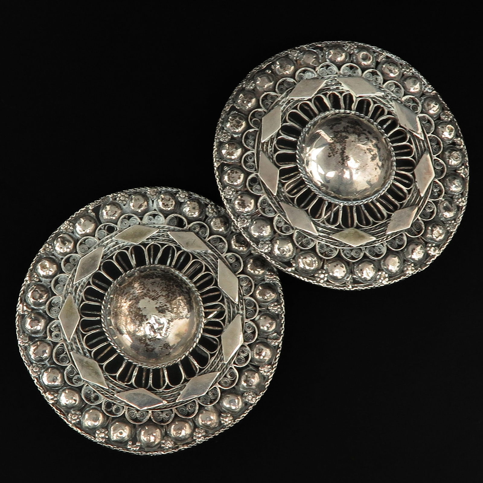 A Pair of Dutch Silver Broekstukken: Year letter 1919, from South-Beveland traditional costume, diameter 100 mm.